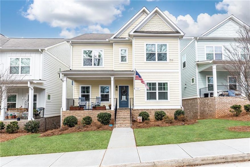 $2,500 seller concession towards rate buy down or anything of buyers choosing. Sought-after 4/3 plus bonus room in Marvelle.  This like-new beauty greets you with a rocking chair front porch patio and an inviting foyer.  Gleaming hardwoods flow throughout the main level. Fireside living room opens to a bright chef's kitchen featuring a large granite island with seating, white cabinets, granite countertops, gas cooking, and SS appliances, along with a breakfast area. Family room opens to a large deck (great for entertaining). Separate formal dining room. Guest bedroom on main level w/ full bath. 3 bedrooms upstairs including oversized primary suite with 2 walk-in custom closets. Primary's bath features a luxurious separate soaking tub, glass walk-in shower, and granite top double vanity. Laundry room on upper floor.  Terrace level features a finished room perfect for a home gym or an office. Stubbed bathroom and ample storage on bottom floor. Rear facing 2 car garage. Additional parking located in front of home on Washington Ave. Monthly HOA fees include lawn maintenance. Marvelle features sidewalks, a large dog park and green space for enjoying the outdoors. This stunning home is conveniently located near highways and is 5 minutes from Marietta Square. ***This home qualifies for 100% financing with no PMI!!***