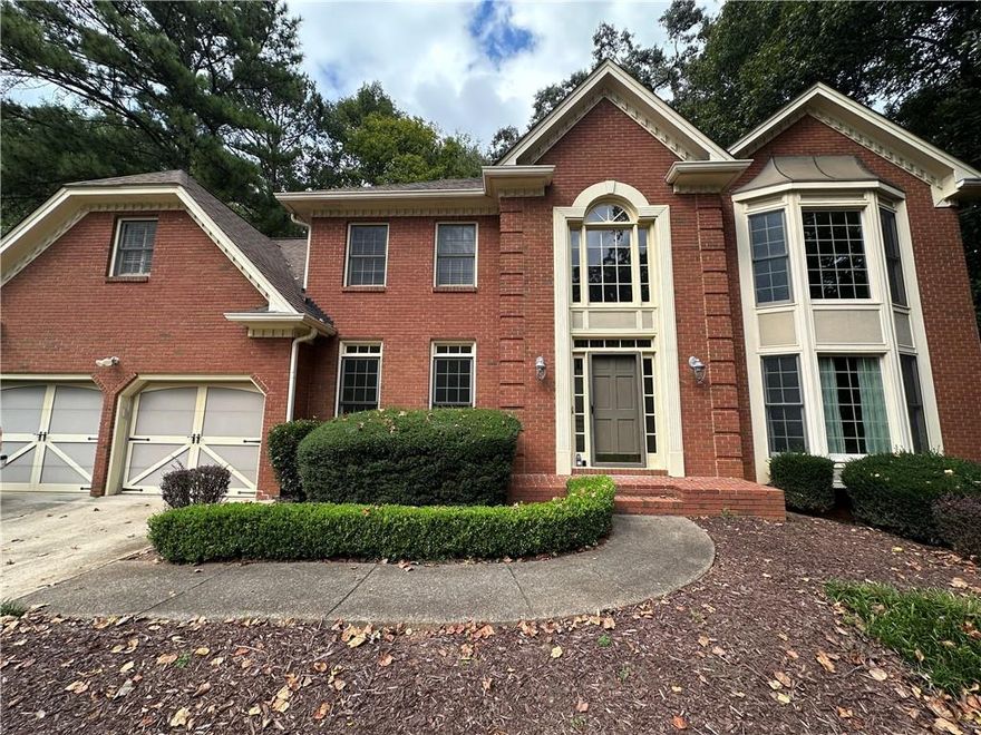 Take advantage of all the equity this home offers and make it your own!!! Spacious four bedroom home in Pope High School District Freshly updated with new carpet and paint throughout, this beautiful home is move-in ready! The inviting two-story foyer opens to a formal living room and dining room, perfect for gatherings. The large kitchen seamlessly connects to the family room, creating an open, comfortable living space. Upstairs, the primary suite features a bay window sitting area, a spa-like bath with soaking tub and separate shower, plus a generous walk-in closet. A private guest/teen suite with its own full bath and stairs to the kitchen offers added flexibility. Enjoy outdoor living with a screened porch, open deck, and private backyard, ideal for relaxing or entertaining. The basement provides abundant storage. Located in the highly sought-after Pope High School district, this home offers both comfort and convenience.