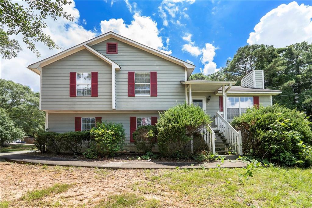 Charming split-level home on a spacious corner lot! This 4-bedroom, 2-bathroom property offers a versatile layout with a finished lower level that includes a fourth bedroom—ideal for guests, a home office, or additional living space. The living room features vaulted ceilings and a cozy fireplace, creating a warm and inviting atmosphere. The generously sized kitchen includes a bright eat-in area, perfect for everyday dining. Outside, enjoy the large yard with plenty of space for play, gardening, or entertaining.