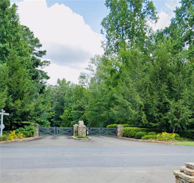 Discover your slice of North Georgia paradise with this beautiful property located in the scenic mountains of Ellijay. Nestled in a peaceful setting surrounded by nature, this lot offers the perfect opportunity to build your dream mountain retreat or forever home. Tranquility at Carters Lake is a gated community offering a playground, creek-side swings, picnic shelters with grills, and a craftsman neighborhood pavilion. Minutes from Carters Lake with a boat ramp and picnic area. The land provides both privacy and convenience, tucked away in a quiet area yet still convenient to the charming downtown Ellijay area with its local shops, dining, and seasonal festivals. Outdoor enthusiasts will love the proximity to hiking trails, rivers, vineyards, and award winning orchards that make this region such a desirable destination. Neighboring Blue Ridge GA has even more shopping, dining, and year around entertainment! Whether you envision a cozy getaway, or a spacious home with sweeping porches, this property gives you the flexibility to bring your vision to life. No matter the season, you’ll enjoy the beauty and tranquility that Ellijay is known for. Also, zoned for the highly rated Gilmer School District. Don’t miss your chance to secure a piece of land in one of Georgia’s most sought-after mountain communities!