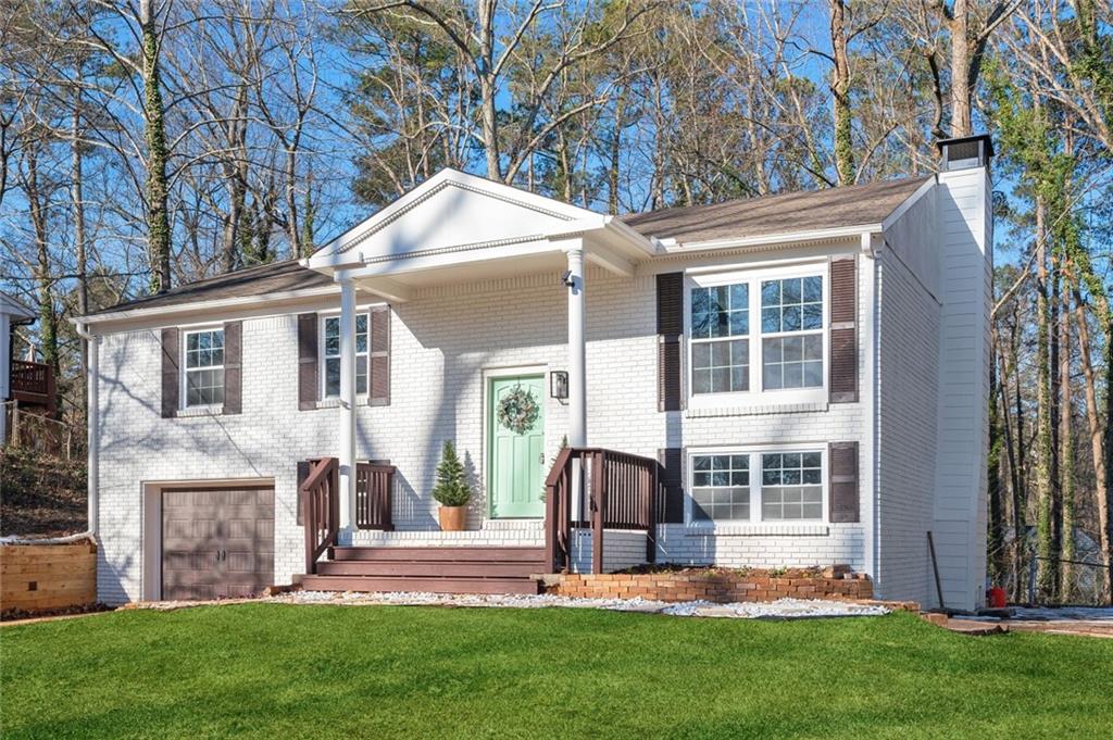 Welcome to “Marietta’s Modern Marvel,” a thoughtfully updated 1,741 sq. ft. West Cobb gem where classic design meets modern flair! This 4-bedroom, 2.5-bathroom home features a timeless bi-level floor plan with stylish upgrades. The charming three-sided brick exterior has been enhanced with white-painted brick, stained shutters, a new garage door, and a stunning stone walkway leading to a paver patio—perfect for cozy evenings around a fire pit.
The oversized backyard is ideal for entertaining, with a screened porch, open deck, and plenty of space for gatherings. Inside, enjoy an open floor plan with a custom herringbone backsplash, sleek granite countertops, and freshly painted cabinets with trendy black hardware. The living room glows with new recessed lighting, while rich laminate flooring ties the space together. Down the hall are two updated bathrooms, the primary suite, and two additional bedrooms for privacy and comfort.
The lower level is the highlight, featuring an extra bedroom, a farmhouse-style brick fireplace, and a flexible space perfect for a media room, game room, man cave, or private suite. Don’t miss this West Cobb treasure—schedule your tour today!
