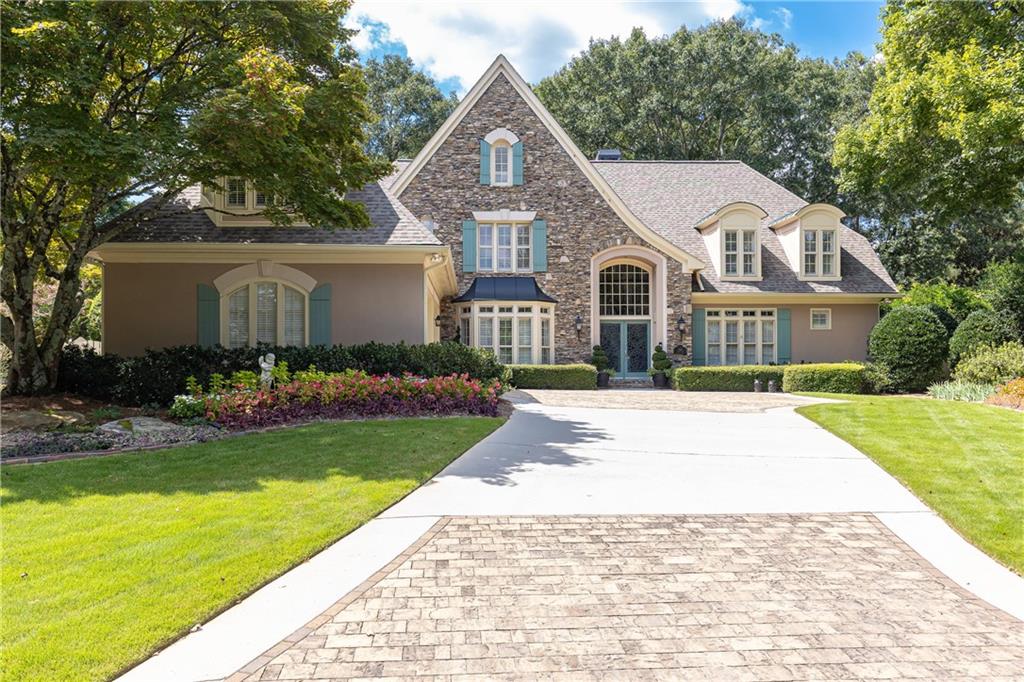 Located in the highly sought-after Ward Meade swim/tennis community in East Cobb, this beautifully maintained 5-bedroom, 4.5-bath home blends comfort, charm, and convenience—along with access to top-rated schools. Set on a serene, level, professionally landscaped lot, the property offers private gate access to the neighborhood’s swim and tennis amenities, ideal for active families and entertaining. The home welcomes you with an elegant entry featuring a curved staircase and a light filled dining room that opens to a step-down living room with a fireplace flanked by custom bookcases. A separate paneled office with built-in bookcases provides the perfect setting for work or study. The spacious floor plan includes a MAIN LEVEL PRIMARY SUITE with a beautifully renovated bathroom, two walk-in closets, and private courtyard access. The oversized family room serves as a central gathering space and flows seamlessly into a warm, inviting keeping room just off the renovated kitchen. Upstairs, you’ll find three additional ensuite bedrooms, each with its own updated bathroom, offering privacy and modern comfort for family or guests. A large bonus room provides flexible space for a playroom, home office, 5th bedroom or gym. Renovated bathrooms throughout the home add a touch of luxury, while thoughtful architectural details and abundant natural light create a welcoming, elegant atmosphere.
With its functional layout, stylish updates, and unbeatable location, this home offers an exceptional lifestyle in a quiet, amenity-rich neighborhood.