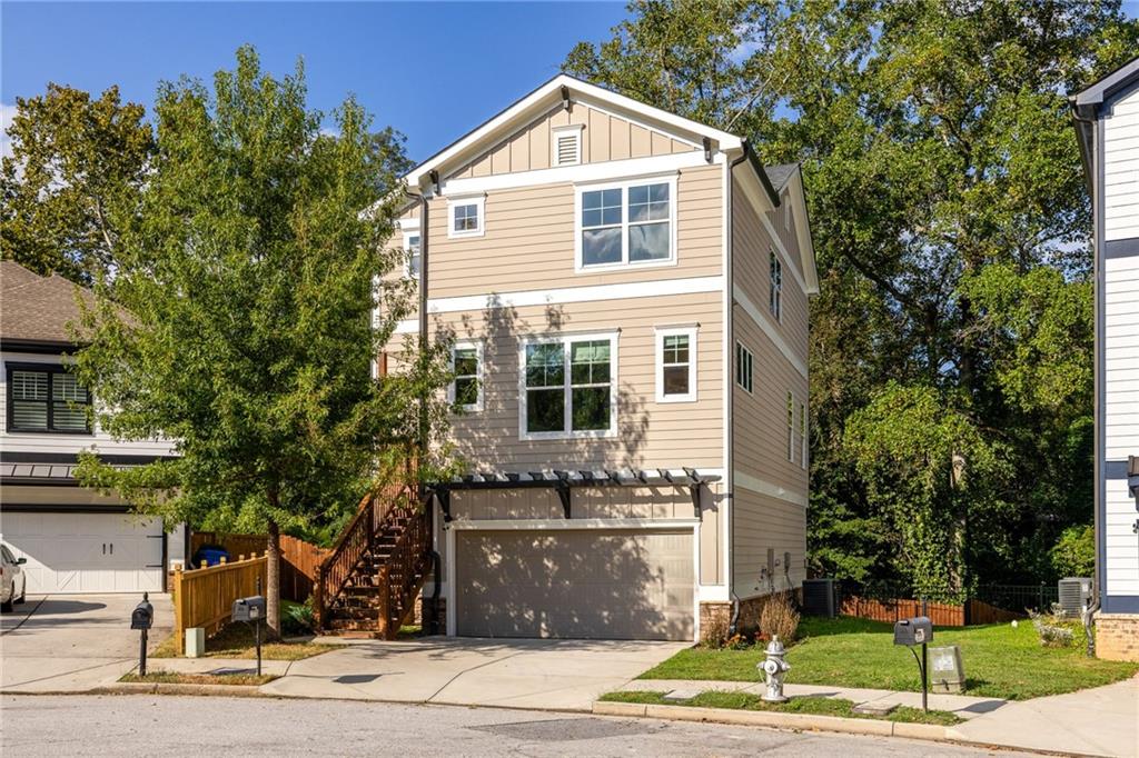 Tucked at the end of a peaceful cul-de-sac, this 4-bedroom, 3.5-bath craftsman offers the best of both worlds: a sense of retreat surrounded by a welcoming neighborhood. Built in 2021 on an oversized wooded lot, it combines comfort, community, and convenience within the highly regarded Burgess-Peterson school zone. Just a short stroll away, East Atlanta Village provides endless dining, shopping, and festivals, while at home you’ll enjoy the balance of quiet surroundings and easy connection.
Inside, thoughtful design and flow create spaces that feel both polished and inviting. Sunlight spills across hardwood floors, illuminating the open layout. The chef’s kitchen, complete with quartz countertops, custom tile, and modern appliances, seamlessly connects to a spacious living room anchored by a gas fireplace, with a separate dining room designed for gathering.
Upstairs, find three bedrooms including the primary suite that showcases vaulted ceilings, a generous walk-in closet, and an oversized double shower. The lower level provides flexibility with a private bedroom and landing - ideal for hosting guests, creating a home office, or carving out a dedicated retreat.
Out back, the home opens to a true entertainer’s dream: an expansive deck for outdoor dining, a fenced yard for play and relaxation, and plenty of space to gather beneath the trees. A two-car garage adds convenience and storage, rounding out the ease of everyday living.
Here, you’ll find walkability to East Atlanta Village, proximity to the BeltLine, and quick access to major highways, placing the entire city within easy reach. This home offers not just a place to live, but a lifestyle that balances privacy, connection, and the best of Atlanta living.