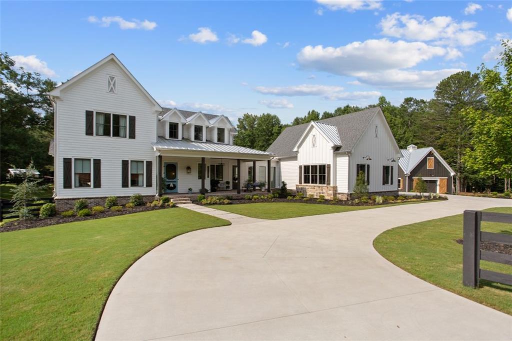 YOUR SECOND CHANCE AT A ONCE IT A LIFETIME OPPORTUNITY! Now is your chance to own an E-Craft Original Custom Modern Farm Home. This is truly a slice of heaven. So many features to list here but the high points deliver what makes this home so desirable.  This is a thoughtfully reimagined nearly NEW CONSTRUCTION (1 year) Modern Rustic Barn Home has it all. Covered bricked southern porch, Two Story open Foyer, Oversized Master on Main with Luxurious SPA BATH and zero edge shower, Open Concept with soaring ceilings and clerestory windows. 16 FEET of Glass with double Sliders opens to HUGE outdoor covered deck with fireplace and views to custom pool and acreage. 3 generous sized Bedrooms upstairs, one with ensuite bath, including Den and Office Space. Full Basement ready too finish! The grounds are spectacular! Experience your very own resort lifestyle with the custom inground pool and generous decking and terrace level living all finished in high level ceramic tile decking to resemble weathered wood decking. Lastly, there is plenty of room to bring your horse or just some mini goats and chix for fun! Additionally an oversized custom barn has been added for utility or the Fun collectible car you have been yearning for. The main level 3 car garage is MASSIVE easily accommodating a full size suburban with room to open the doors and elevated roof and doors to park a boat on trailer. Lastly this home is ENERGY efficient with spray foam insulation throughout. These E-Craft originals are highly sought after and never last long. So now is your chance to own a future collectible home for many years to come!