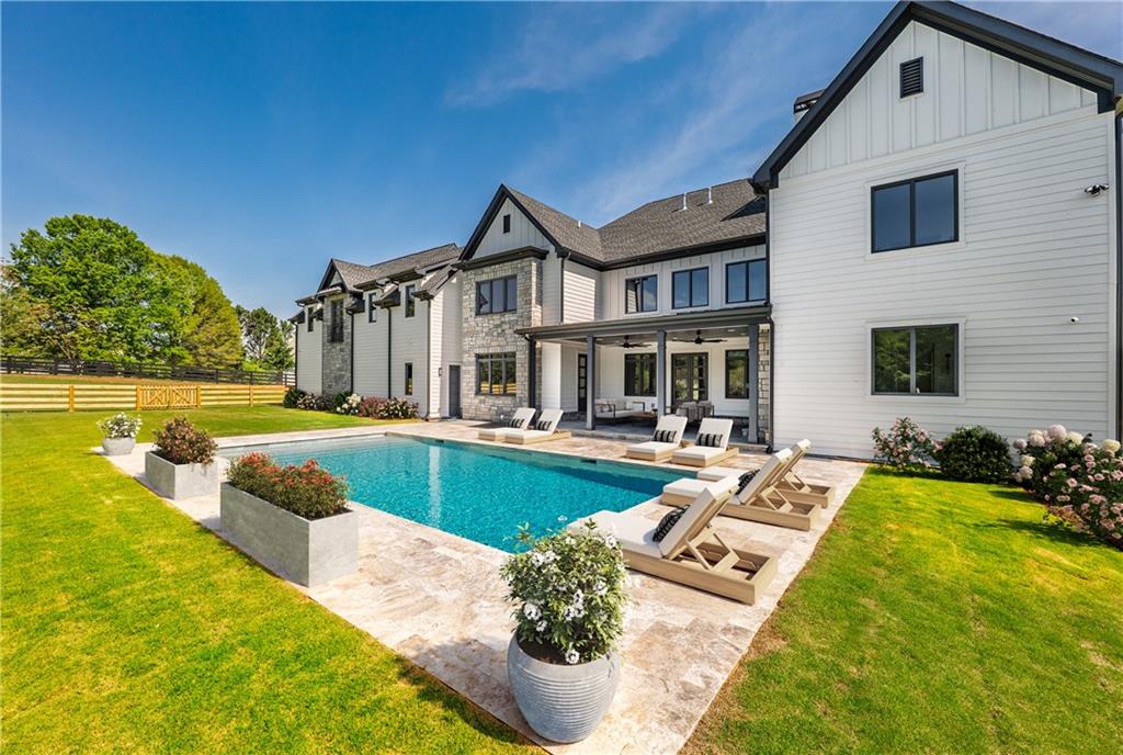 JUST LISTED!! This home gives new meaning to custom-built.
Set along Milton’s scenic and serene Ebenezer Road, this custom-built, new construction home with walk-out level pool offers the tranquility of country living with every city convenience just minutes – even steps - away.
The heart of the home is both a chef and designer's dream kitchen featuring custom, built-in Sub-Zero refrigerator and freezer drawers, dual Miele ovens (including steam), Miele gas cooktop, Wolf range hood, and a hidden appliance cabinet—all framed by custom Karpaty cabinetry and luxury quartzite countertops. A scullery kitchen adds convenience with a second dishwasher and additional storage.
A soaring two-story great room, stunning floor-to-ceiling, cast stone fireplace anchors the main level, while the expansive owner’s suite offers a true retreat with its own fireplace, large walk-in shower, soaking tub, dual vanities, and a flexible dressing room/additional closet or office. Every bathroom throughout the home is outfitted with premium Kohler fixtures and under-cabinet lighting for both style and functionality.
Additional main-level amenities include a full bath with direct pool access, a large laundry room, mudroom connected to a spacious three-car garage with full extension.
This home offers three full-size owner’s suites, including the main-level primary, a second luxurious suite on the upper level, and a private, fully outfitted suite ideal for a teen, au pair, or multigenerational living. Each suite offers en-suite baths, walk-in closets with California Closets systems, and designer finishes throughout. The onyx countertops in the main level primary suite are truly stunning. Upstairs also includes two additional spacious bedrooms, each with private baths and built-in features, plus a second laundry room for added convenience.
The finished terrace level expands the home’s luxury with an expansive fireside living area, game room, playroom, home gym, a custom-built Harvia dry sauna and massage room. A full guest suite, kitchenette, and extensive storage space complete this level with both practicality and polish.
Outdoors, enjoy a private backyard oasis with a new heated saltwater pool, a covered back porch with gas fireplace, lush landscaping, and a dedicated pool bath entrance—all designed for entertaining and relaxation.
Behind the scenes, this home is equipped with a whole-house generator, whole-home water filtration system, dehumidifier for the terrace level, and a 10-camera security system. Built-in speakers, an intercom system, and whole-home surround sound wiring make entertaining seamless. GEALAN German-engineered luxury windows, Restoration Hardware/Pottery Barn lighting, imported Italian tile, custom cabinetry and exquisite custom millwork and trimwork elevate the home’s lasting value.
Set along beautiful, pastoral Ebenezer Road, this home delivers the serenity of country living with every city convenience just minutes away. Walk to the Georgia Golf Center or Milton’s 106-acre Lakhapani Nature Preserve, and enjoy being less than three miles to the vibrant shops, dining, and community events of Crabapple and downtown Milton. All three top-rated public schools—Crabapple Crossing Elementary, Northwestern Middle, and Milton High—are within minutes, as are several prestigious private schools. Quick access to GA-400 and multiple downtown destinations (Roswell, Alpharetta, Milton & Avalon).
