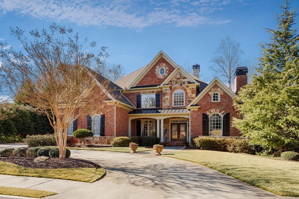 NEW PRICE - Elegant Mediterranean Style Brick and Stone home on over an acre Lot. Spectacular paradise-like level backyard, custom designed patio with great views of the golf course.Heavy detailed trim work seen throughout the home. Chef's kitchen adjacent to breakfast room & vaulted keeping room with tongue and groove cypress ceilings. The exquisite gentleman's study off the foyer is flanked with wood paneling,coffered ceiling and fireplace. Main level Master Suite includes a jetted tub, travertine shower and large master closet with custom closet system.