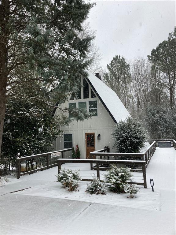 Fully renovated in 2020. As seen on VRBO. Rare find A-Frame cottage with full wrap around deck with plenty of room to host the entire family on hot summer day cookouts. Head down to the back yard and enjoy the massive fire pit with views of the lake in the distance! This A Frame has a bed and bath on every level. The home comes fully furnished. Turn key ready for VRBO or AIRBNB permit already in place. Bring your boat and store on your single slip covered dock that is roughly a hundred yard walk, no long winding hills to climb to get there. Swimming, or floating around on hot days are waiting for you and your family. Less than ten minute drive to near by shopping and north Ga premium outlets, Publix and other retail. The north end of the lake is much quieter and relaxing.
SELLER IS A LICENSED AGENT IN THE STATE OF GEORGIA