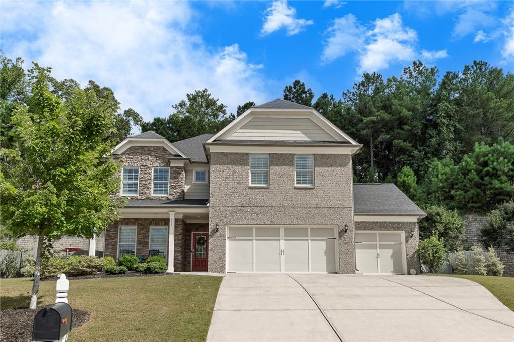 Tucked away on a peaceful cul-de-sac in one of Cherokee County’s most sought-after communities, this stunning 4-bedroom, 3.5-bath retreat in Woodmont offers a luxurious blend of comfort and resort-style living on over half an acre of meticulously landscaped grounds. Step inside to an open, light-filled layout where soft grey tones, custom designer lighting, and warm hardwood floors create an inviting, sophisticated ambiance. The gourmet kitchen is a chef’s dream, featuring dove grey cabinetry, gleaming white quartz countertops, stainless steel KitchenAid appliances, a convection oven/microwave, under-cabinet lighting, and a massive island that flows effortlessly into a cozy family room with a dramatic floor-to-ceiling stacked stone fireplace. Enjoy the flexibility of two spacious master suites—one on the main level with a spa-like ensuite bath showcasing a glass-enclosed rain shower and bench, and another upstairs with dual walk-in closets and a serene en-suite bath. Every upstairs bedroom offers generous walk-in closets and surrounds a central loft/game room area with an additional full bath and abundant storage. French doors lead to a versatile flex room perfect for a home office or formal dining, while a built-in planning center off the kitchen adds even more functionality. Step outside and feel the serenity wash over you in the private backyard oasis, where a covered lanai with built-in Klipsch outdoor speakers overlooks a heated 14' x 30' saltwater pool featuring a stacked stone waterfall, underwater bench, and tanning ledge—ideal for entertaining or unwinding under the stars. With hookup for a gas grill, automatic pool vacuum, and thoughtful upgrades like new carpet throughout the upstairs, wood-slat window blinds, and an irrigation system, every detail has been curated for ease and enjoyment. A spacious 3-car garage and ample storage complete the home, while community amenities include pools, tennis, pickleball, a playground, clubhouse dining, and optional golf memberships at the Robert Trent Jones Jr.-designed championship course. Located near top-rated schools, shopping, and dining, this exquisite home truly offers the best of refined, easy living. This home won't be available for long... schedule your showing today!!