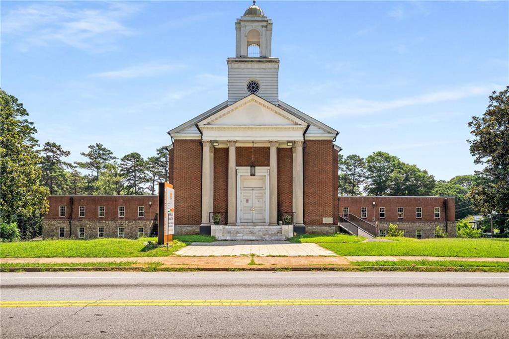 Unlock the potential of this expansive 30,000+ sq ft freestanding building set on over 3 acres in the sought-after Sylvan Hills neighborhood 2 blocks from Perkerson Park and 2 blocks south of the Southside & Southwest Beltline! Currently used as a place of worship, the property offers a full sanctuary with seating for 500+, a balcony level, numerous classrooms and offices, ample restrooms, and generous meeting and fellowship areas. Additional features include a commercial-grade kitchen, a solid concrete basement, and updated flooring in select areas. Currently zoned R4 and located near Opportunity Zones, this versatile space is ideal for a variety of uses— a business headquarters, church facility, production studio, community center, or redevelopment. All of this offers you quick access to GA-166 and just minutes from Tyler Perry Studios, East Point, College Park, and Hartsfield-Jackson Airport, it offers unmatched visibility, convenience, and long-term potential.