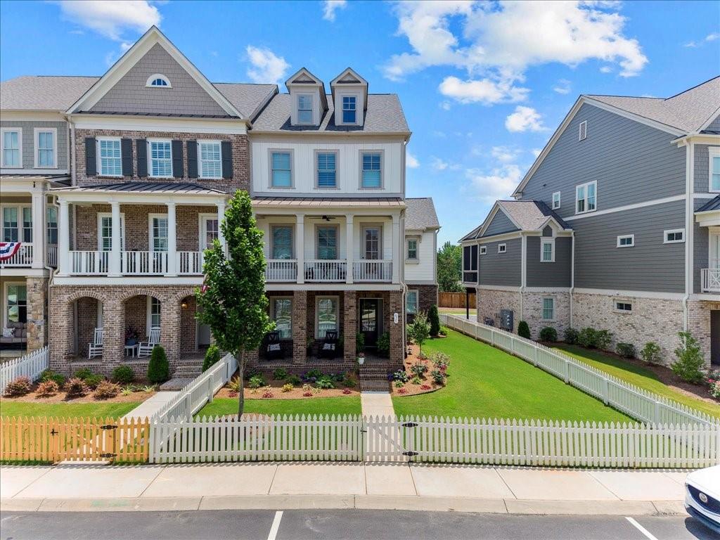 Luxury 3 Bed / 3.5 Bath Corner Townhome with High-End Finishes & Premier Amenities -Super Close to Downtown Woodstock in Sought-After South on Main!
Welcome to this stunning, elevator-ready luxury town home, situated on an oversized fenced corner lot located within a half mile to downtown Woodstock! It offers a rare combination of elegance, space, and resort-style community living. Featuring 3 bedrooms, 3.5 baths, and a 3-car garage, this brick and Hardie Plank home is packed with upgrades and thoughtful architectural detail. Step inside to real hardwood floors throughout the first two levels and a formal living room highlighted by an upgraded brick fireplace with cedar beam mantle and custom built-in bookshelves. The large open dining area includes upgraded trim and a dry bar - perfect for entertaining. The chef’s kitchen boasts stainless steel appliances, upgraded cabinetry, quartz countertops, a large island with bar, abundant recessed lighting, a herringbone tile backsplash, and a designer stainless steel vent hood. It flows beautifully into a keeping room with a cedar beam ceiling detail and into the spacious family room - ideal for hosting guests. Enjoy outdoor living with double front porches and a screened-in back porch with Trex flooring. The home also features custom shutters throughout for added style and privacy. Upstairs, you’ll find a versatile loft/desk area, a large primary suite with separate his-and-hers walk-in closets, and a spa-like primary bath with custom cabinetry included added vanity, a separate soaking tub, and a seamless entry shower with a bench seat & shampoo nook. A spacious secondary bedroom with its own private bath, plus a tiled laundry room with upgraded cabinetry, complete the upper level. The terrace level includes a third bedroom and a full bath, along with a mudroom/drop zone perfect for organization.
Community amenities include Clubhouse, fitness center, two dog parks, resort-style pool and splash pad & cabana, community Garden, outdoor amphitheater, fire Pit & Playground, and running/walking Trail with access to the Noonday Trail! This is more than a home – it’s a lifestyle! Don’t miss your opportunity to own one of the most upgraded and ideally located properties in the community!!!