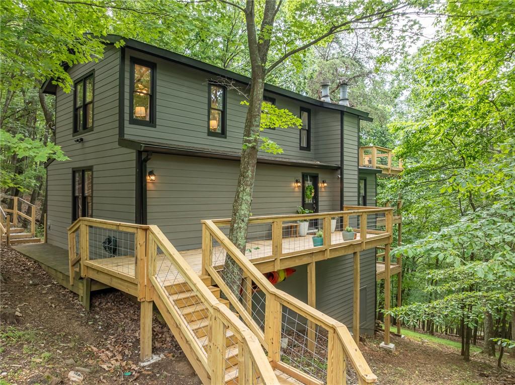 Welcome home to Cutthroat Ridge! Perched on a crest here you will enjoy your own slice of nature and might even get a chance to meet Bambi or Goldilocks and the three bears! This home is located within the sought after community of Bent Tree. Enjoy the fresh mountain air and long weekends on the multiple covered decks, plenty of level spaces for outdoor seating.
Here you will be nestled in a private lot with seasonal mountain views, just over an acre with lots of room for entertainment or just listening to the birds.
Cuddle up to a cozy fire on a crisp autumn night on the main deck, with the outdoor smokeless fire table or inside snuggled in front of the multiple indoor fireplaces. Inside you are greeted by the open-concept style of living, kitchen and dining spaces. Sliding doors allow lots of natural light. The kitchen is fully functionable and renovated with a wide drop-in matte black composite granite sink white cabinets and granite countertops with all new stainless-steel appliances.
You will find gorgeous mixed-width LVP flooring throughout with oak stair treads, handrails and landings with inset tile accents handrails.
The 3-bedroom, 2 full bath home is ready to move into as a full-time residence or can be used as a short-term rental, long term rental or a weekend vacation home. One bedroom is on the main floor with 2 additional bedrooms upstairs. Both bathrooms are updated with all new plumbing fixtures and tile floors.
Recent improvements are - refinished asphalt drive, Electric Breaker panel, 3 new decks, front porch walkway, steps up to the parking pad, new windows, lights and ceiling fan fixtures and many more ask for the list!
Outdoor enthusiasts and active individuals will love the gated golf cart community. Bent Tree boasts a plethora of resort style amenities including the 110 Acre Lake for Swimming, Fishing, Kayaking, and Boating. The Joe Lee Designed 18 Hole Golf Course and clubhouse and restaurant, 2 swimming pools, an Equestrian center with trail rides, hiking trails, indoor and outdoor tennis and pickleball courts, and of course a dog park for your furry companions. Bent Tree even has a private Fire Department. You will also have access to some of the best health care from several nearby hospitals, be able to enjoy local Wineries, Breweries, Restaurants and shopping.