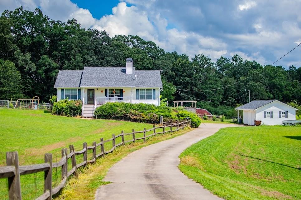 Discover the perfect blend of comfort, recreation, and country charm in this beautiful 5.19-acre slice of
country paradise. With 3 fenced pastures (and room for a fourth), it's ready for your horses, livestock,
or hobby farm dreams. A 30x40 barn with sheds on each side offers flexible space for keeping animals
separate, each with pasture and barn access. If you love entertaining, you can do it with ease in your
backyard oasis. The sparkling saltwater pool has a computerized system that keeps it perfectly balanced,
while the pergola offers a shady retreat. Flower gardens spill over with color, framing a space that is as
beautiful as it is inviting. When the day cools, head to the game room where you will find a custom bar
and pool table (that stays), setting the stage for good times. For everyday living, the main level
encompasses durable flooring and a cozy fireplace. Enjoy your morning coffee either on the deck that
overlooks the pool area or your front porch that offers peaceful views. The detached 2-car garage with
workshop and extra storage shed gives you all the space you need for tools, hobbies, and gear. The new
roofs as well as the whole-home generator, are added bonuses. Bring your animals, bring your friends -
This place is ready for fun, farming, and forever memories. Schedule your appointment today!
