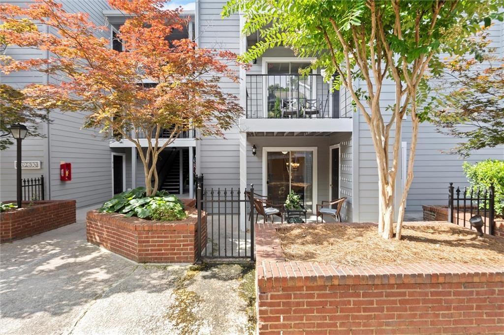 Tucked inside a uniquely gated community in the heart of Sandy Springs, this light filled condo offers effortless living convenient to everything you need—shopping, dining, parks, and unbeatable access to GA-400, I-285, and MARTA. open-concept layout with a mixture of hardwood, tile and carpet, and a spacious living room with fireplace that opens to your private patio—perfect for morning coffee or unwinding at sunset. The kitchen boasts newer cabinets, quartz countertops and a breakfast bar. This floorplan even has a cozy dining space. The bedroom features a large walk-in closet. The laundry room off the kitchen houses a full-size washer and dryer with additional pantry/storage. Bonus: unit comes with a designated parking space in a gated/covered garage which makes accessing your unit a breeze via the elevator. Granville Court offers resort-style amenities including a pool and fitness center.