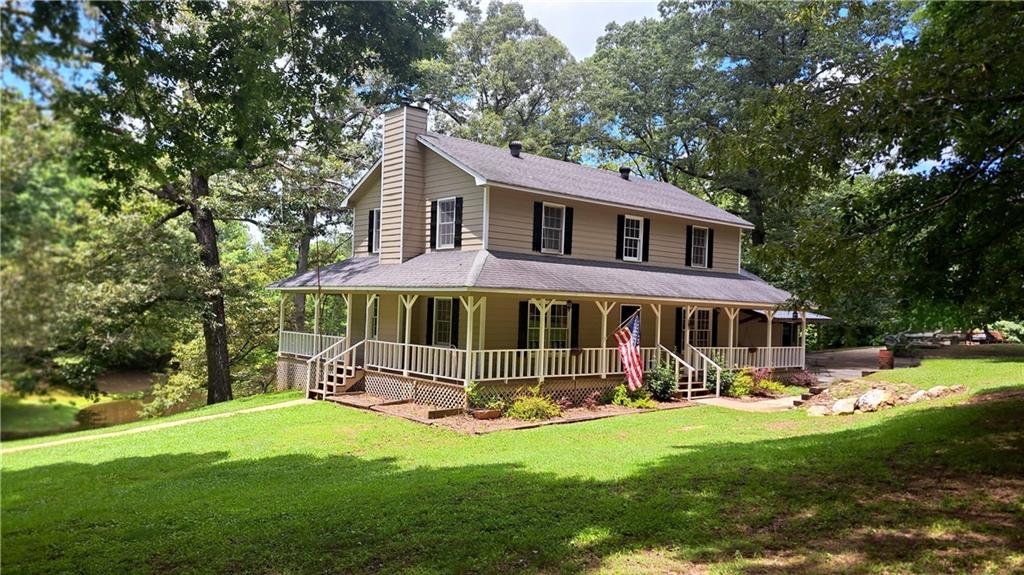 Welcome to a peaceful country retreat on 11.21 acres of natural beauty and rustic charm. Tucked away in a quiet rural community, this property offers space to roam, a slower pace, and the kind of setting that makes you want to stay awhile. The home features a classic country design, complete with a wraparound porch that invites you to relax and enjoy the surrounding landscape. Whether you're sipping coffee in a rocking chair or watching the sun set over the trees, it's the perfect place to unwind. On the side of the home, an inground pool offers a private spot to cool off in the summer or host gatherings with friends and family. Out back, a serene, stocked lake adds to the property's appeal—ideal for fishing or simply enjoying the peaceful, natural surroundings. There's also a barn with a loft and a separate equipment shop, providing plenty of space for storage, hobbies, or animals. Inside, the home features wood columns, hardwood floors, and a cozy wood-burning stove that add warmth and rustic character. Natural light pours in through the windows, and every room reflects the comfort and simplicity of life in the country. Tucked away in the quiet of the countryside, this property offers the kind of privacy and space that's hard to find—yet still within reach of nearby towns when needed. Whether you're looking for a weekend getaway, a full-time homestead, or a place to put down roots, this one offers the land, the charm, and the potential to make it your own. Come explore everything this special property has to offer.
