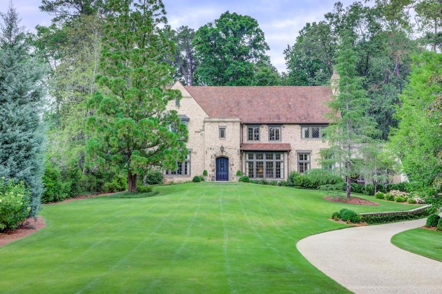 This custom-built creation, the product of Frank Neely, Davey Construction, Graham Pittman, and creative original owners, with interior design by Alison Jowers, Womack/Jowers Interiors, is located on a deep and private lot in the heart of Buckhead.  Built to blend old and new, a Ludowici tile roof (reclaimed off a factory in Missouri) brick and stone exterior give the home a true historic appearance despite being built in the 2010s.  As you enter the home, you will be welcomed to 12 ft+ high ceilings, soaring mahogany windows, and the perfect amount of indoor and outdoor space.  No detail is overlooked.  From hardware selections, wide plank quarter sawn oak floors, leaded windows, cypress beams, a solid oak hand-carved handrail leading upstairs, intricate molding, and the reuse of historic pieces, a guest is quickly aware of the craftsmanship it took to create this modern masterpiece.  The main level features a large family room open to a covered porch accessed through metal doors, an oversized dining room, formal living room, an intimate study with fumed wood walls with doors leading to the deck overlooking the back yard, a casual dining room, home office, mud room, and absolutely stunning kitchen with wood beams, plaster ceilings, walk in pantry and adjacent bar.  Upstairs you will find four bedrooms, including the spacious primary suite.  The primary suite features a splendid ensuite bath, a closet built for today’s needs, a private living space retreat overlooks the captivating back yard.  Upstairs you will also find one of two laundries, a common area perfect for a kid hangout out space, and three well-sized secondary bedrooms with en-suite baths. Venturing down to the terrace level, you will be greeted by tall ceilings and brick floors, making the space warm and inviting.  The terrace level has loads of living and entertaining spaces, a secluded guest bedroom with driveway access, an additional laundry room, and a walk in wine cellar.  Retreating to the flat, walkout back yard, you will find truly spectacular landscaping, a gorgeous pool, flat play yard, and one of the best guest/pool houses in the city.  The guest/pool house has peacock pavers and feels as though it has been pulled directly from an Alys Beach ocean front estate: it is an absolute treat.  This is a rare opportunity to purchase a custom-built home (finished in the last 10 years and crafted by an incredibly talented team of professionals), situation on a magnificent lot and found on one of the best streets in the city.