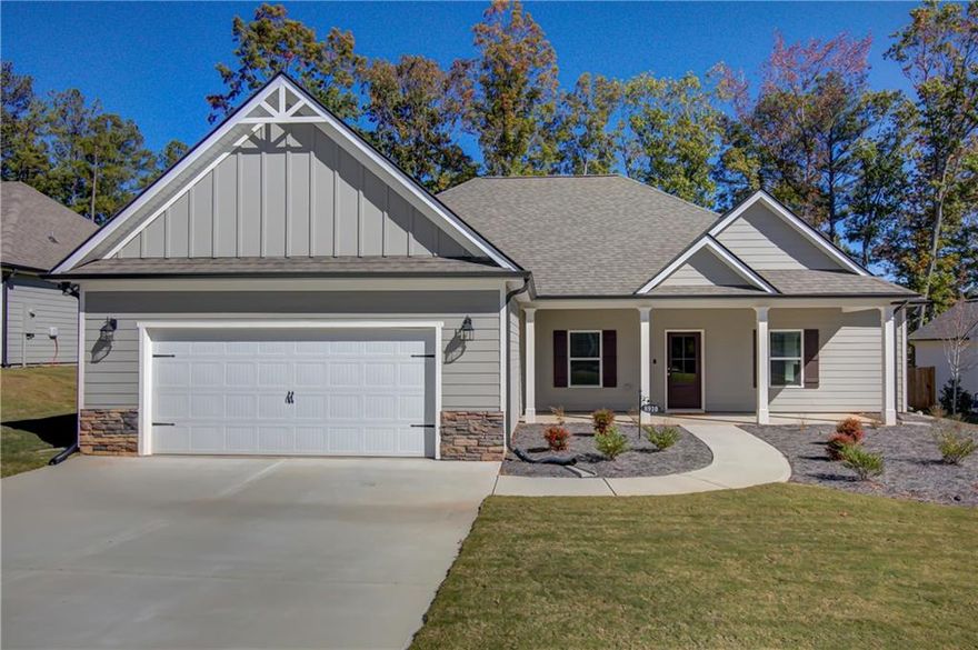 Better Than New! This stunning 4-bedroom 2.5 bath ranch offers modern style, smart design, and beautiful golf course views. The open- concept layout features a spacious kitchen with a huge island and breakfast bar, seamlessly connected to the expansive family room with a cozy fireplace- perfect for entertaining or everyday living. A flexible 4th bedroom with barn doors just off the kitchen makes an ideal office, playroom or guest space. The primary suite impresses with a stylish accent wall, a spa-like bath with soaking tub, separate tiled shower, and an oversized walk-in closet. The split bedroom plan offers privacy with two additional spacious bedrooms and a full bath on the oppposite side of the home. The mudroom includes custiom built-in storage and a large laundry area for everyday convenience. Relax outdoors on the covered back porch overlooking the golf course, and enjoy the garage equiped with a 50-amp EV outlet- ready for your electric vehicle.