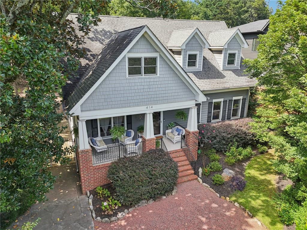 As you walk up the front pathway of 414 Pensdale, you will immediately feel a sense of calm and peacefulness. The front porch welcomes you to sit down and relax in this charming Craftsman style home that is unique in so many ways. Inside this stunner, you will find 5 bedrooms and 3.5 baths with 3,200 SF and much of the home has been remodeled and is in impeccable condition. On the main floor there are 2 bedrooms and 1.5 baths and a separate dining area that holds 8+ for your friends & family gatherings and a large open chef's kitchen that looks over to a stunning stone fireplace in the living room.
If you are a gardener or a landscape lover, this home is perfect for you with its lush and mature gardens in the front and backyards. The back of the home is 100% private and is equipped with a security gate that provides access to the back yard and to the detached two car garage. Entry in to the back of the house through the charming screened-in porch allows for easy access to the kitchen. The back of the house boasts a wonderful screened porch with all sorts of character and charm. Upstairs, you will find 2 oversized bedrooms with a double sized primary suite with a double vanity, a stand up shower as well as a soaking tub. This home has high ceilings and hardwood floors throughout! It is located in the desirable Ridgeland Park neighborhood and it is just a hop skip and a jump away from the Decatur square with quaint shops and popular, classic restaurants as well as Glenlake Park, Marta, the Dekalb County Farmer's market! Come quickly to see this perfectly maintained Craftsman beauty!