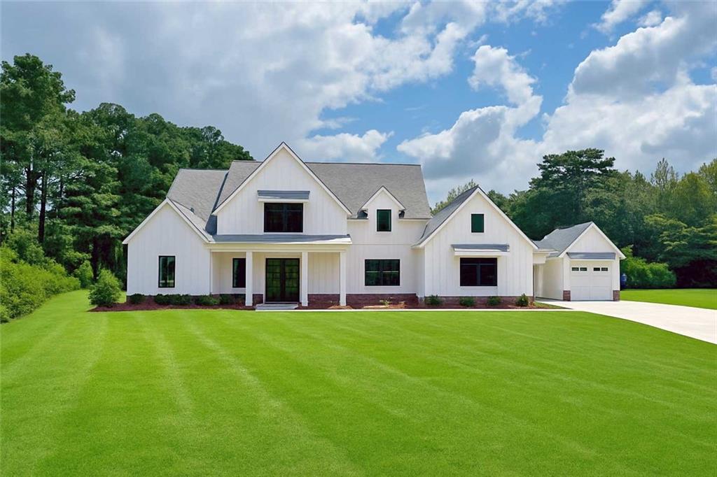 Welcome to this stunning NEW CONSTRUCTION home, nestled on a level and private 0.92-acre lot in an exclusive enclave of just five custom homes in an A+ Woodstock location. With a striking elevation and impeccable curb appeal, this residence offers refined luxury, thoughtful design, and energy-efficient features throughout.
Step inside from the covered front porch to a vaulted family room anchored by a beautiful fireplace, featuring custom built-in cabinets and floating shelves on each side. A spectacular 16-foot sliding glass door opens to a spacious covered rear patio with its own cozy fireplace—ideal for entertaining or quiet relaxation while overlooking the private, level backyard, perfectly suited for a future pool.
The main level features a luxurious primary suite with a spa-inspired ensuite bath, showcasing a zero-entry shower, designer tile, quartz countertops, and dual custom walk-in closets. A separate guest suite with its own zero-entry bath, a large laundry room, and a well-designed mudroom add everyday convenience.
The gourmet kitchen is a showstopper with an oversized island, quartz countertops, a slide-in range, abundant cabinetry, and a separate dining or breakfast room for effortless entertaining. A stunning switchback staircase leads to the second floor, where you'll find two spacious bedrooms, each with its own ensuite bath, and a versatile bonus room perfect for a den, office, or playroom.
Built with comfort and efficiency in mind, this home includes spray foam insulation, a tankless water heater, high-efficiency HVAC, and low-maintenance vinyl windows. Every corner reflects quality craftsmanship and luxurious detail—this is Woodstock living at its finest.