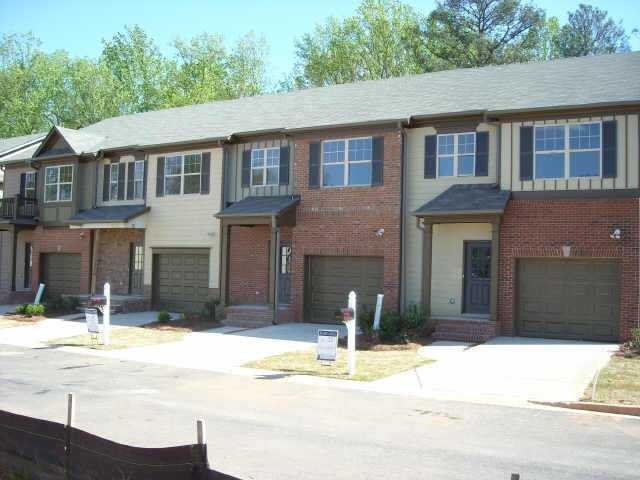 Unbelieable Value Near the Lake! 2 Fabulous Master Suites, Finished Basement, 3 1/2 Baths, Private Wooded Back Yard, 42' Cabinets, Corian Counter Tops, All Maintenance Included! Beautiful upgrades! Next door to Lanier Country Club, which is a public 18 hole golf course.