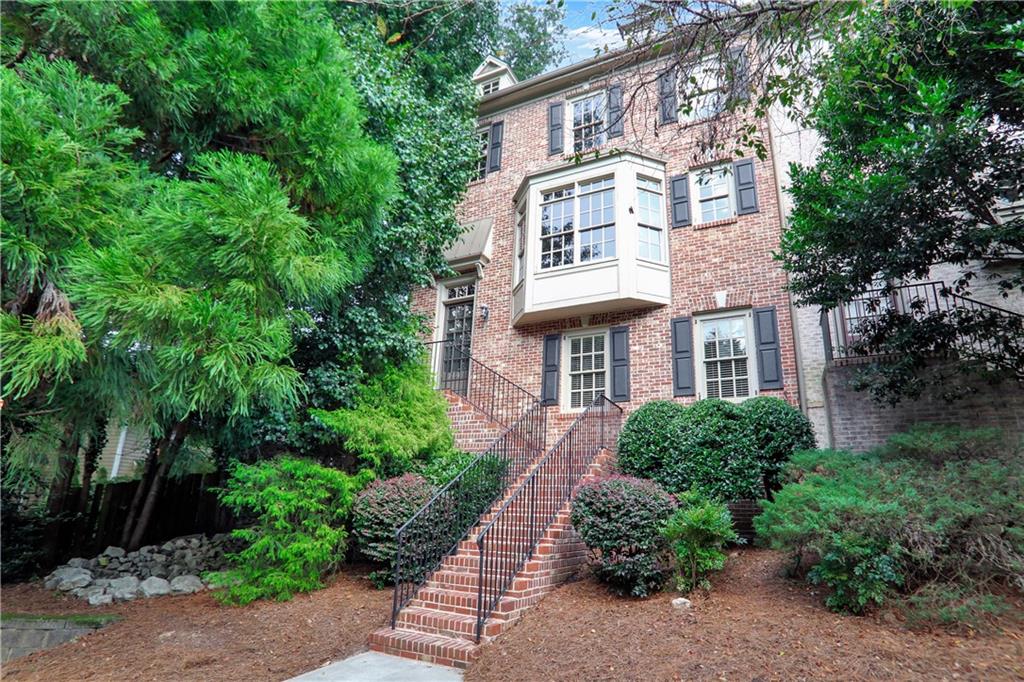 Welcome to this stunning end-unit townhome, brimming with natural light and thoughtful design. The open-concept main level feels more like a single-family home, offering seamless flow throughout. The chef’s kitchen features granite countertops, gas cooktop, double ovens, KitchenAid stainless steel refrigerator, and a spacious pantry with a clever office nook. The living room impresses with its stone fireplace, dining space, and easy access to the private deck perfect for relaxing or entertaining. A separate dining area at the front of the home is framed by a beautiful bay window. Upstairs, the expansive primary suite offers a large bedroom with an additional sitting area and fireplace, a spa-inspired bath, and TWO oversized walk-in closets. Another spacious bedroom, full bath, and convenient laundry room complete the upper level. The lower level provides a two-car garage, ample storage, plus a private bedroom and full bath ideal for guests or a home office. All of this in an unbeatable location, just minutes to the vibrant shops and restaurants of Oak Grove, with top-rated schools nearby and easy access to Emory, CDC, and the new CHOA campus.