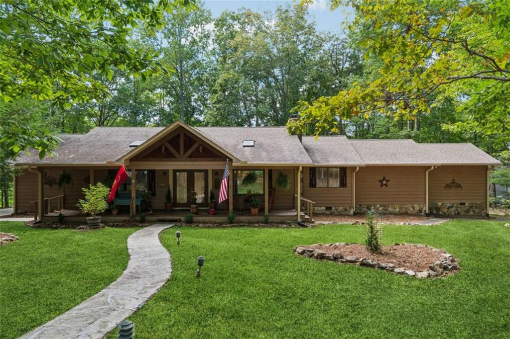 Discover one of the most sought-after locations in the gated Bent Tree community, where convenience meets tranquility. Perfectly positioned with easy access to both the front and back gates, this fully renovated 3-bedroom, 3-bath ranch offers 2,209 sq ft of thoughtfully designed living space on a sprawling 1.44-acre lot along the shores of the 110-acre private, fully stocked Tamarack Lake. A level front yard and newly poured concrete driveway with additional stone parking pad welcome you to the charming rocking-chair front porch. Inside, hardwood floors flow throughout the main living areas, accented by a ship-lap wall and original masonry fireplace with new gas logs and remote starter. The open-concept living, dining, and kitchen area overlooks the expansive backyard, complete with stepping stones to a serene lakefront viewing spot. The chef's kitchen is a showpiece, featuring an oversized quartz island with seating and storage, stainless steel appliances including an induction cooktop with convenient pot filler, double convection wall oven, in-built microwave drawer, and wine cooler. A double undermount sink frames peaceful lake views. Retreat to the renovated guest suite with a sitting room, tiled bath, and direct access to the vaulted screened porch-ideal for enjoying vibrant seasonal views. The owner's suite boasts built-in closets, a freshly updated bathroom with stepless tile shower, and enhanced year-round comfort with additional HVAC vents hooked up to a brand new hybrid dual-fuel heating and air conditioning system. Additional updates include new windows throughout (2025), fresh paint inside and out, 10" depth spray foam insulation in attic, gutter guards, a 2024 whole-home Generac generator, April Air dehumidifier, and freeze-proof spigots. Just minutes away, enjoy Bent Tree's unmatched amenities: a golf course with the 19th Hole Tavern, Beach Pavilion where you can enjoy beach volleyball, bocce and basketball. Premier pickleball and tennis facilities, two pools, clubhouse, hiking trails, walk-in access to Eagle's Rest park, a dog park, and the newly renovated library and Bent Tree Animal Shelter - a safe haven for lost cats and dogs. Added benefit of 24/7 EMT security for emergency situations. With electric-motor boating allowed on Tamarack Lake, along with boat storage and boat launch, your backyard is a year-round playground. This is more than a home-it's a lakefront lifestyle in Bent Tree's premier setting.