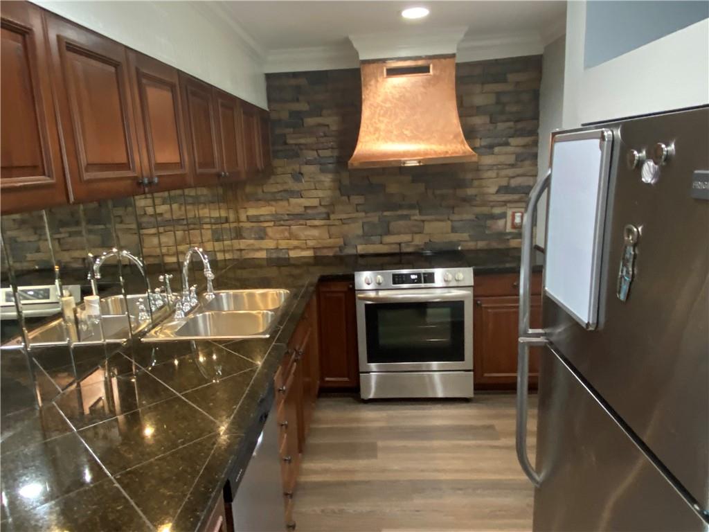 Very Nice Ground Floor Unit!  Open Concept with Beautiful New Luxury Vinyl Flooring!  Gorgeous Remodeled Kitchen with Granite Countertops, Glass Backsplash and Dark Cabinetry!  Stainless Steel appliances! Large Living room/Dining Room Combo with Recessed Lighting!  French Doors open to private Fenced Courtyard!  Patio area partially covered! Large Owners bedroom with Walk in Closet!  Updated White Bathroom!  Great Community with Underground Utlitileis and Olympic Sized Swimming Pool.  Fitness Center!  Water/Sewer and Trash INCLUDED in the rent!  $75 per person application fee with 3 times monthly rent as income, 650+ TransUnion Credit Score and Excellent Residential History required.   Per must be approved by Owner on per pet basis.