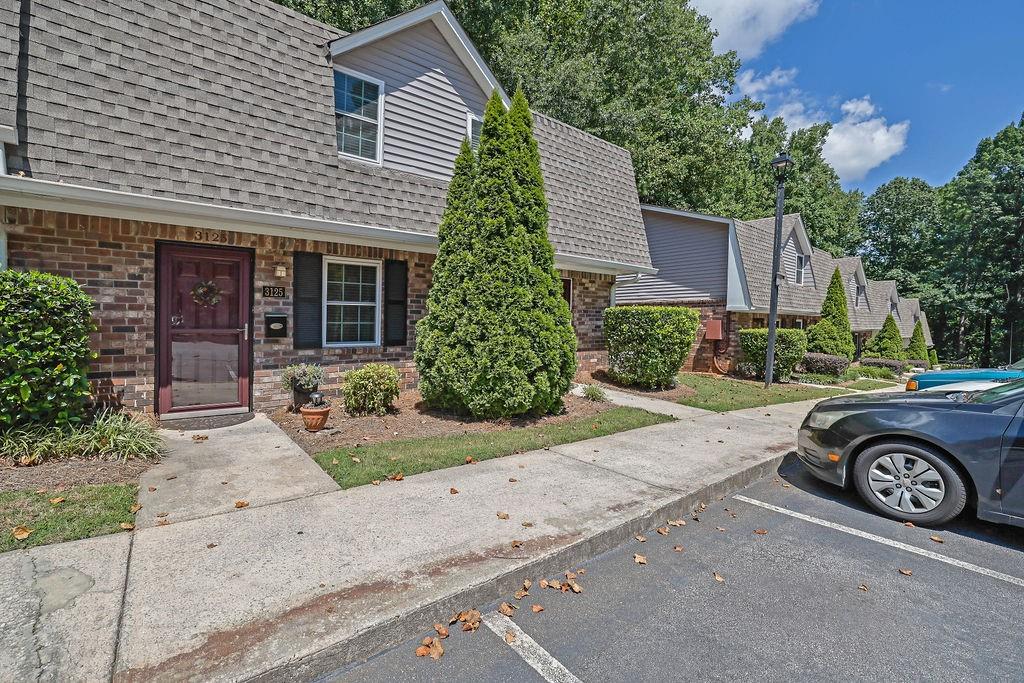 This home is a hidden gem! Nestled in a quiet, tucked-away community right in the heart of Smyrna, this charming 2 bedroom, 1.5 bath condo offers the perfect blend of tranquility and convenience. Step inside to find a separate dining room, an updated kitchen with new cabinets, countertops, and backsplash, and LVP flooring throughout the main level. Enjoy the natural light from brand-new windows and a sliding glass door that leads to a private back patio overlooking peaceful wooded views. Fresh paint throughout and a beautifully renovated tile shower in the main bath add to the move-in ready appeal. You'll love the ample parking, a great community pool, and a location that can't be beat—just minutes from I-75, The Battery/Braves Stadium, Cobb Galleria, Cumberland Mall, and tons of dining and entertainment options.