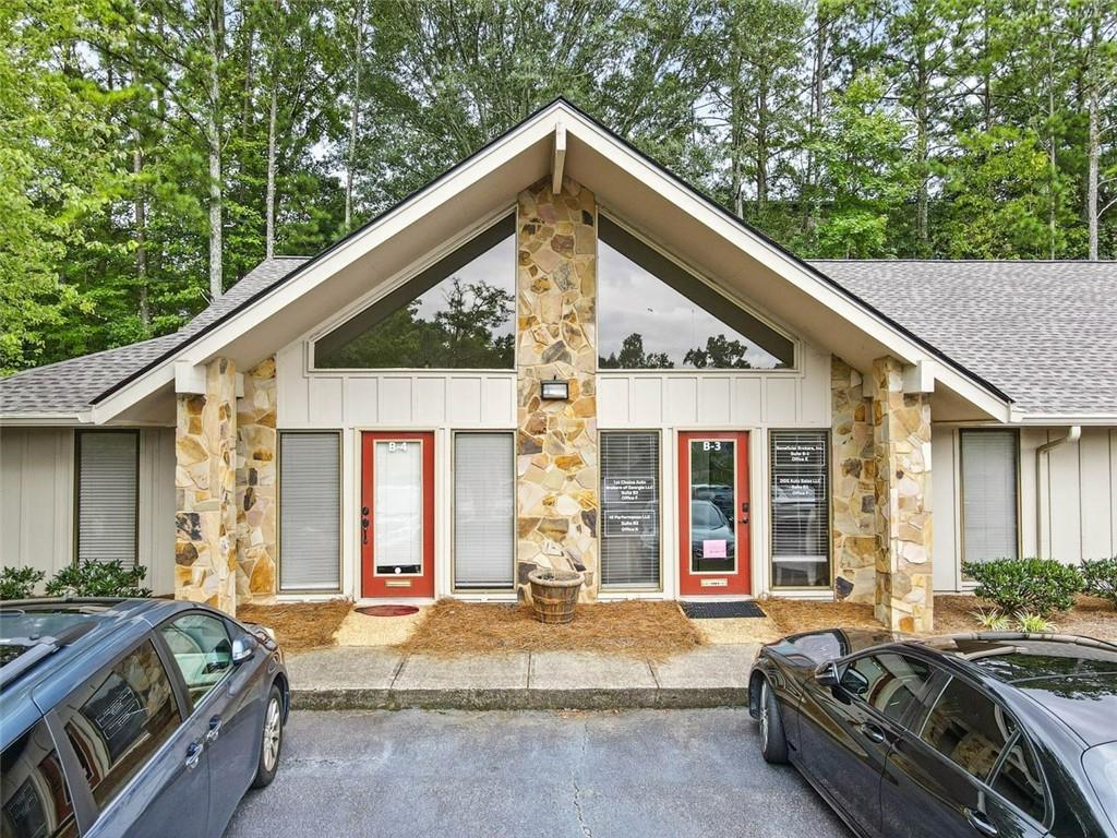 Versatile office space in a Prime Roswell Location! This 1,026 SF unit offers a functional layout with 4 private offices, 2 updated bathrooms with new vanities and flooring, and a kitchenette with sink. A private front entrance opens to a spacious Reception/Waiting area with vaulted ceilings, creating a welcoming first impression for clients and guests. In addition, the suite includes 2 flexible rooms - ideal for small workspaces or easily converted to storage. Situated in Corporate Woods, a peaceful wooded office park off Elkins Road, the property offers a private and professional setting with convenient access to Holcomb Bridge Road, GA-400, and nearby dining and retail. The well-maintained complex features new roofs throughout and ample on-site parking. The office is currently leased to multiple tenants on month-to-month agreements. Tenants may be retained for investment income, or the space can be used for the owner’s business operations.