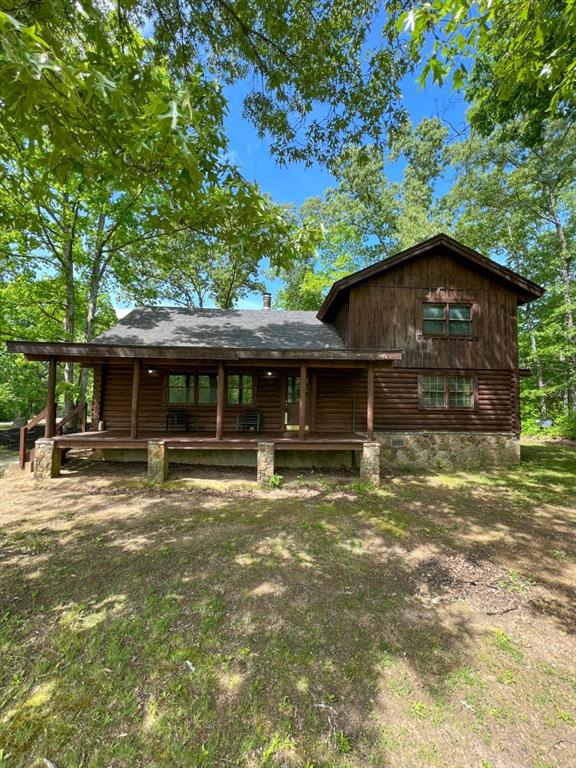 Peace, quiet, and privacy! Come check out this freshly updated log cabin centered on a beautiful 8.8 acre lot that has endless potential. Previous owners had a mini-farm operation with chickens, ducks, goats, rabbits, and more as this property has no restrictions. This property backs to nearly 300 acres of undeveloped nature plots making this an excellent home for hunters, recreational ATVs, etc. Pinhoti trail is nearby for avid hikers. A garden plot has been prepared and ready for this season's gardener. Plenty of entertaining space offered by the covered front porch, perfect for early morning coffee sipping while taking in the beautiful scenery, or the rear deck which would be great for those nights you cook out on the grill. This home is located on a dead-end street with breathtaking, seasonal mountain views that could be year-round with a little time and a chainsaw. This cabin has a rustic and charming interior featuring many wood accent walls, exposed rafters, and vaulted ceilings. Hardwood floors installed throughout the shared spaces while new carpet is installed in all bedrooms. A beautiful stone-faced wood burning fireplace will help keep you warm in the winter. The kitchen features a large layout with new granite countertops, stainless steel appliances, and a breakfast bar. There is a dining location in the great room AND the dining room off the kitchen. Additional storage includes a walk-in pantry, under-stair storage, and utility closet off the mudroom which is also plumbed and ready for a half bath for that extra bathroom on the main level. Owner suite is on the main level and includes double closets and a large bathroom with shower and a double vanity as well as an additional space for a closet/storage just off the bathroom. The upstairs features a spacious loft, 3 large bedrooms with large closets, multiple closet storage, and an additional bathroom. A majority of the light fixtures have been upgraded. The home features a brand new HVAC 4-ton system, a 30 year architectural shingle roof installed in 2019, a newer water heater installed in 2021, a well as a backup system for irrigation, and additional attic floor storage. Convenient location just minutes from downtown for grocery shopping, and dining. Experience the mountain town of Chatsworth surrounded by nothing but natural beauty. 1 hour 45 minutes from Atlanta; hour from Chattanooga; 25 minutes from Ellijay; 25 minutes from Calhoun; 20 minutes from 1 Dalton. Schedule your showing before it is too late. Come turn this paradise into your home before it is too late. Seller is a licensed GA Real Estate Agent.