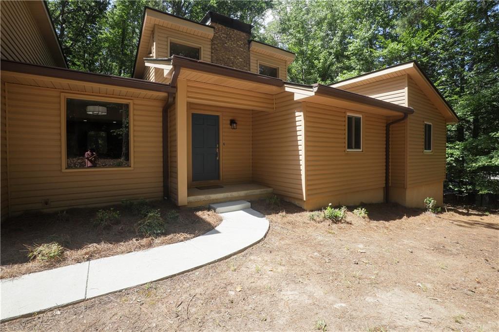 Welcome to 765 Spring Valley Dr, a beautifully updated ranch-style home nestled on a quiet, wooded lot in Cumming, GA. This spacious home offers 3 bedrooms and 3 full bathrooms—all on the main level—including a large master suit. Located just minutes from Lake Lanier, GA-400, and The Collection at Forsyth, you’ll enjoy quick access to top-rated schools, shopping, dining, and outdoor recreation. Inside, vaulted ceilings, exposed beams, and a dramatic brick fireplace create a warm, open feel. The kitchen features stainless steel appliances, gas cooking, and a sunny bay window, while the expansive deck invites you to relax or entertain surrounded by nature. With over an acre of wooded privacy, and quick access to hiking trails, shopping, boat ramps, and everyday conveniences, this home is perfect for anyone looking to rent in a great school zone and well-connected area.