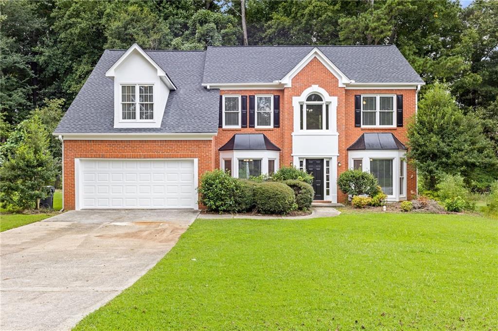Fully Renovated & Move-In Ready Home with Main-Level Handicap Accessible Suite! Welcome to 9665 Knollcrest Blvd a beautifully updated 5-bedroom, 3.5-bath home located in the desirable Coldstream Courts neighborhood of Alpharetta (Johns Creek area). This home features a brand-new roof, new windows, fresh paint, new hardwood floors, and updated lighting throughout, offering the perfect blend of style, comfort, and accessibility. The thoughtfully designed main-level bedroom includes wide doorway access, and a private handicap-accessible full bath with a roll-in shower ideal for multigenerational living or guests with mobility needs. The bright, open main level also includes a welcoming two-story foyer, formal living and dining areas, and a cozy fireside family room that opens to a sunny breakfast nook. The fully updated kitchen features granite or quartz countertops, stainless steel appliances (including a new gas range), ample cabinet space, and a view into the private backyard perfect for gatherings, gardening, or play. Upstairs, you'll find the spacious primary suite with tray ceilings, a luxurious en-suite bath with soaking tub, separate shower, double vanities, and generous closet space. Two additional bedrooms share an updated hall bathroom, all with new carpet and paint. Additional upgrades include: new garage doors, updated HVAC, new water heater, new roof, and modern fixtures throughout. Nestled in a swim/tennis community with access to walking trails, playgrounds, and minutes from top-rated schools (State Bridge Crossing ES, Autrey Mill MS, Johns Creek HS), this home is just a short drive from GA-400, Avalon, Big Creek Greenway, and top golf and nature amenities.