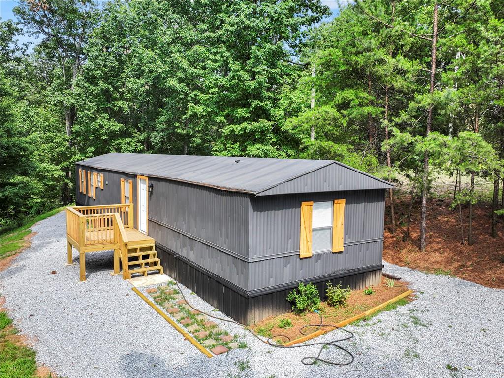 Tucked away on a peaceful, wooded lot, this fully renovated 3-bedroom, 2-bath home is the perfect escape for those who live for the outdoors. Whether you’re into hunting, hiking, trail riding, or simply unwinding in nature, this property offers the space and freedom to do it all.
Step inside to find a fresh, modern interior with brand-new flooring, updated lighting, and a bright open-concept layout. The kitchen features stylish finishes and plenty of prep space, ideal for cooking up a hearty meal after a day in the woods. The primary suite includes a spacious bathroom and walk-in closet, creating a cozy retreat all your own.
Outside, the real adventure begins. Surrounded by mature trees and wildlife, the property offers endless possibilities—build a fire pit, set up hunting blinds, or explore the natural trails right from your backyard. With no HOA and plenty of room for your trucks, trailers, and gear, this property is made for freedom.