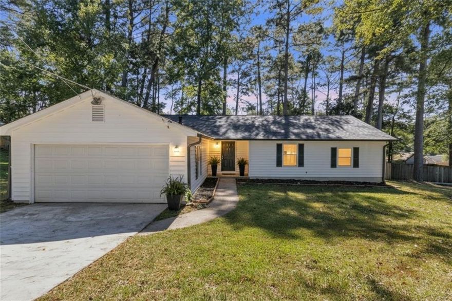 This fully renovated 4-bedroom, 2-bath home offers approximately 1,634 sq ft of modern living space, seamlessly blending fresh upgrades with charming surroundings. Nestled on a quiet, wooded cul-de-sac lot of about 0.43 acres, the property provides privacy and an expansive fenced backyard perfect for outdoor living. Step inside to find a fresh, inviting interior featuring brand-new flooring and paint throughout, an open living area with a cozy fireplace, and a stunning kitchen with white cabinets, gleaming countertops, and stainless steel appliances. Both full bathrooms have been beautifully updated with sleek tilework and contemporary fixtures, including stylish LED-lit vanity mirrors. Outside, entertain or relax on the deck overlooking the spacious yard, complete with a firepit area for evenings under the stars. A large driveway provides ample parking for multiple vehicles, and best of all, there’s no HOA to restrict your enjoyment. Truly move-in ready, this home offers modern comfort, ample space, and serene privacy in a convenient Norcross location.