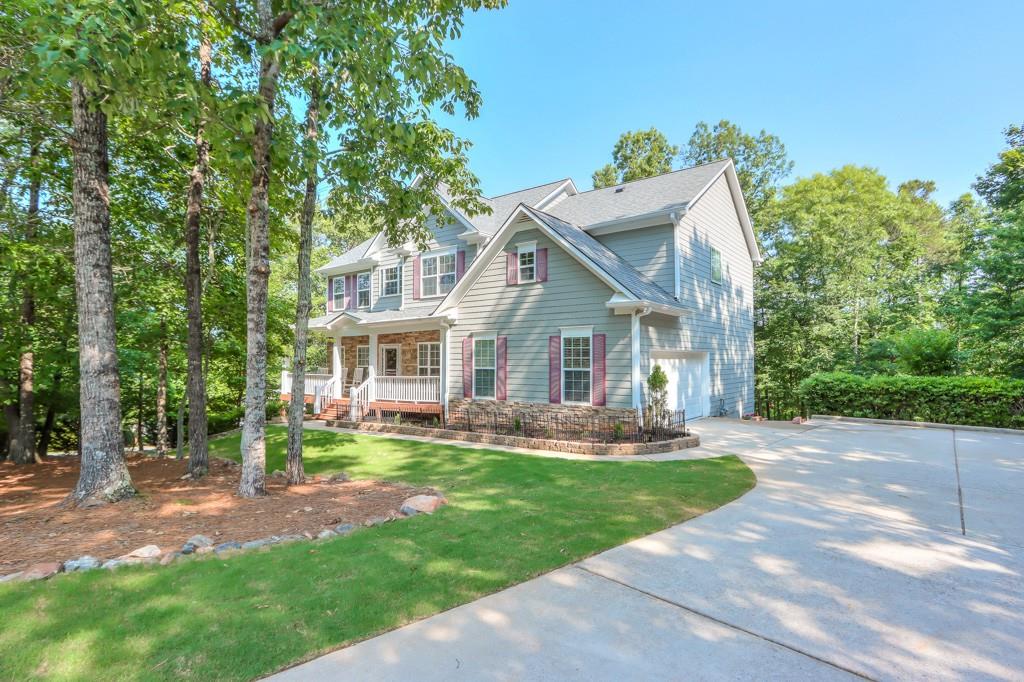 Welcome to your private 6-bedroom 4 bath open floor plan, mountain home located 5 minutes from charming Downtown Dahlonega and 15 minutes from booming Dawsonville. This 1.48-acre oasis offers you a beautiful fenced and landscape yard. This home features the best of outdoor living. The front porch invites you into the gorgeous custom home. Walk through the open entry way to your dream kitchen with custom cabinets and ample counter space. Enjoy year-round view of the foliage from the screened back porch. BEDROOM ON MAIN with full bath. Oversized Master bedroom upstairs with three large bedrooms upstairs. The finished basement opens into an oversized living room. Perfect entertainment space or cozy family hideaway. Basement features custom kitchenette. A large bedroom and a full bathroom. Their STORAGE in this home is amazing. Each floor has amazing storage. Walk out the double doors and enjoy the fenced yard and the outdoor living continues. The professional landscaped yard is just beautiful. You will fall in love with this home!