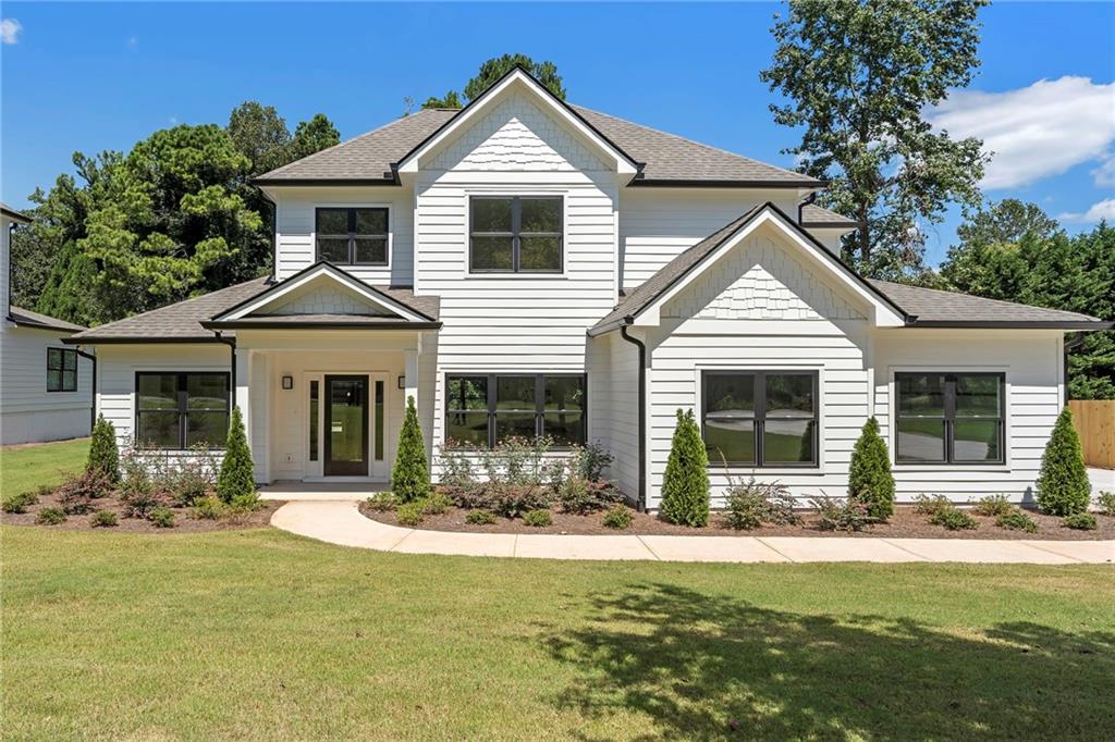 This brand new home is ideally situated just minutes from shopping and dining at Sandy Plains and Shallowford Road, Town Center Mall, and a variety of neighborhood favorites. You’ll also enjoy easy access to recreation at East Cobb Swim & Tennis and nearby parks.
The home is located in the Sprayberry High School district, where the school is currently undergoing a major renovation and expansion—a multi-million-dollar project that will deliver state-of-the-art classrooms, updated athletic facilities, and modernized learning spaces, making the area even more desirable.
Situated on a half-acre lot, this home is loaded with high-end upgrades and luxurious finishes.
A striking two-story foyer greets you upon entry, while the open floor plan, designer lighting, and abundant natural light create a bright and welcoming atmosphere on the main level.
The living room features a sleek fireplace with a marble tile surround, offering a cozy yet elegant focal point for gatherings. The chef’s kitchen is outfitted with top-of-the-line Thermador appliances, including a built-in refrigerator and pull-out microwave drawer. An oversized island, custom cabinetry with double pull-out spice racks, and an adjacent butler’s pantry make this space as functional as it is impressive. A large walk-in pantry adds even more storage.
The primary suite on the main level boasts elegant double tray ceilings, a spacious walk-in closet, and a spa-like bath with dual vanities, an oversized glass walk-in shower, and a soaking tub.
Each bedroom is generously sized and includes its own ensuite bath, walk-in closet, and individual thermostat—a rare and thoughtful feature that ensures comfort and privacy for all. The home also includes a zoned HVAC system and a tankless water heater for maximum energy efficiency.
Upstairs, you’ll find a second laundry room and extra-large secondary bedrooms—perfect for a growing family or out-of-town guests.
Step outside to the back patio, ideal for grilling or relaxing while enjoying the peaceful backyard.
A long, wide driveway offers plenty of parking for guests, multiple vehicles, or even an RV.
Don’t miss your chance to own this beautifully designed, thoughtfully appointed home.