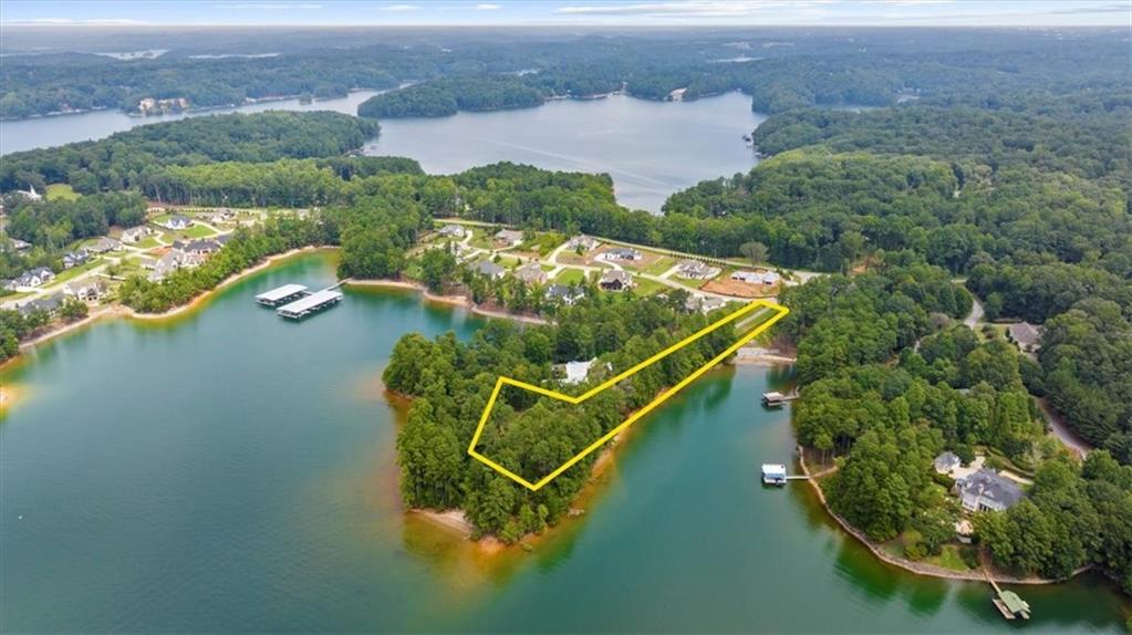 Positioned within the sought after Bay Pointe community, this extraordinary 1.51 acre lake lot with a Private driveway, Gated access and fence, offers an unrivaled setting for your custom estate. Surrounded on three sides by water, with more than 1200 feet of pristine shoreline, a Corps of Engineers walking trail and sandy beaches. the property combines natural beauty and panoramic views with exclusivity and privacy. From sunrise reflections to sunset horizons, every vantage point captures the essence of luxury lakefront living. With a build-ready homesite, you have the rare opportunity to create a residence tailored to your lifestyle—whether it’s a contemporary retreat with walls of glass, or a timeless lakefront sanctuary. This is more than a lot; it’s the canvas for your legacy on the water. Deeded 12 X 28 boat slip, on Dock A, slip 22, provides an easily accessible position. The Community Dock has water and power, and is golf cart accessible. Quick access to Atlanta via I-985/I-85.
Water and electric are on site. Septic needed. House plans are available upon request. Don't miss this opportunity to own your private paradise. Weissman is the preferred closing attorney.