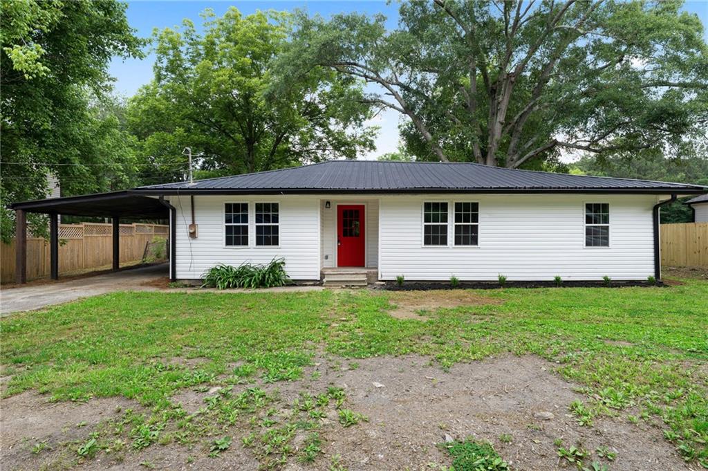 This completely reimagined 3-bedroom, 2-bath ranch is the definition of move-in ready! Taken down to the studs and rebuilt with care. Every detail has been thoughtfully updated from brand-new drywall, electrical, plumbing, and windows, to fresh paint inside and out, new gutters, trim, lighting, and interior/exterior doors. The gorgeous new flooring flows throughout the home, tying each space together with style and warmth. The heart of the home is the expansive open-concept living area featuring a massive brick fireplace with built-in wood storage—perfect for cozy nights in. The modern kitchen boasts a large island, sleek quartz countertops, brand-new stainless steel appliances, and stylish new cabinetry and plumbing fixtures. Both bathrooms have been beautifully renovated, and the spacious layout offers plenty of room for living and entertaining. Step outside to enjoy the covered patio, perfect for relaxing or hosting, and a generous backyard that’s ideal for play or gardening. A carport adds convenience and additional covered parking. This is a rare opportunity to own a home that feels brand new—inside and out—with timeless design and quality craftsmanship. Come see it for yourself!