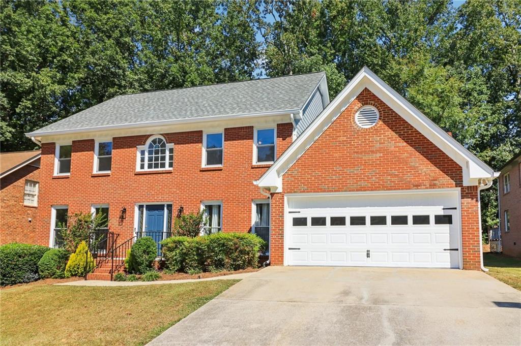 Four-sides brick home with low-maintenance flooring on main and new carpet upstairs. Updated throughout with new HVAC, roof, windows and gutter guards. Bright eat-in kitchen overlooks private backyard. Bedroom suite with full bath on main level plus spacious primary suite upstairs with separate shower and soaking tub. Large secondary bedrooms, lots of natural light. Convenient, stylish, and ready to move right in!