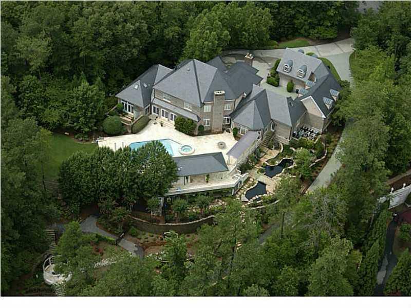 One of, if not the finest, private gated estates ever to become available in Atlanta. Setting on 8.2+/- Park-like acres w/water falls & ponds. Lavish appointments, gourmet kit, Incrediable master suite.  Terrace level features, custom bar, billards rm, wine cellar, home theater seats 10 w/ McIntosh audio equipment, gym/spa w/steam & sauna, Private in-law suite, separate charming guest house, slate roof, swimming pool w/covered pool house w/outdoor bar, Tennis courts, Putting green, Stunning views of the lake from most every room.  Absolutly amazing grounds.