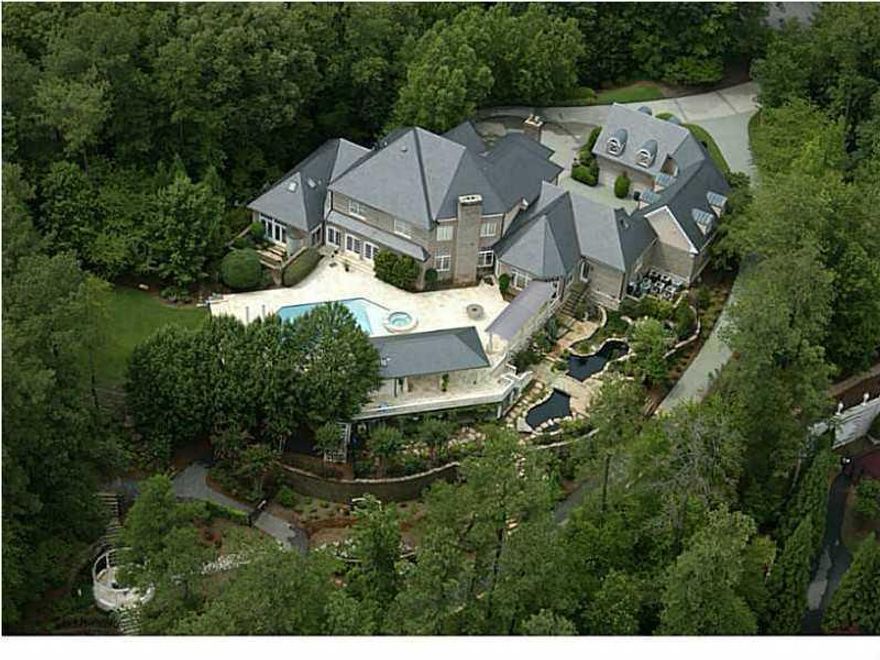 One of, if not the finest, private gated estates ever to become available in Atlanta. Setting on 8.2+/- Park-like acres w/water falls & ponds. Lavish appointments, gourmet kit, Incrediable master suite.  Terrace level features, custom bar, billards rm, wine cellar, home theater seats 10 w/ McIntosh audio equipment, gym/spa w/steam & sauna, Private in-law suite, separate charming guest house, slate roof, swimming pool w/covered pool house w/outdoor bar, Tennis courts, Putting green, Stunning views of the lake from most every room.  Absolutly amazing grounds.