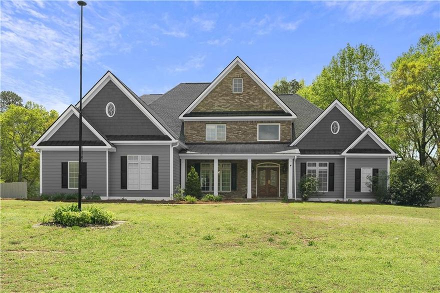 Welcome to this truly exceptional custom built estate nestled on a level two acre lot in sought after East Cobb with NO HOA! From the moment you arrive, the charm begins with a welcoming covered front porch and continues inside, where a grand two story foyer sets the tone for the elegance within. The home boasts nearly 6,000 square feet of beautifully crafted living space, including a soaring two-story great room filled with natural light from dramatic floor-to-ceiling Pella casement windows. Rich cherry hardwood floors, intricate millwork, and thoughtful details like a central vacuum system with a dustpan feature make this home as functional as it is stunning. Designed for both daily living and grand entertaining, the main level features an oversized primary suite with dual walk-in closets and direct access to a spacious tiled screened-in deck overlooking the private, fenced backyard. The gourmet kitchen is outfitted with high-end Kitchen Aid stainless steel appliances and flows seamlessly into a cozy breakfast area and formal dining room. Upstairs, you’ll find three generously sized bedrooms, each with en suite baths, including a secondary master suite with an expansive walk-in closet illuminated by natural light. The full daylight terrace level offers incredible versatility with ten foot ceilings, a second full kitchen, a movie room, game room, and additional living spaces perfect for generational living or entertaining. A covered patio just off the basement provides even more space to enjoy the serene backyard, ideal for a future pool or tennis court! Need storage or workspace? In addition to a three-car garage, there is a fourth rear-entry garage deep enough to accommodate two vehicles. This is more than just a home, it is a lifestyle