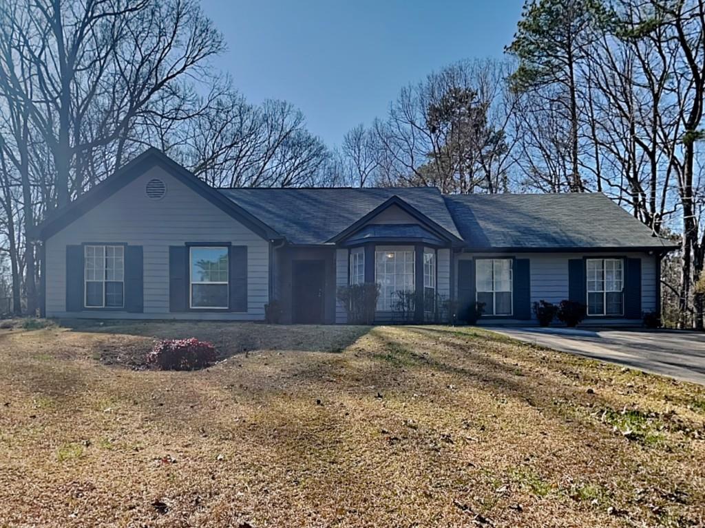 Beautiful home on over half an acre lot! Spacious living room with vaulted ceilings! Stone fireplace! Separate dining room! Kitchen features stained cabinets, black appliances, breakfast bar and dining area! Oversized primary bedroom with his & her closets and private bathroom with garden tub and separate shower! Two spacious secondary bedrooms and two more full bathrooms! Large rear patio overlooks backyard! Shed out back for extra storage! A must see! Don't miss out!