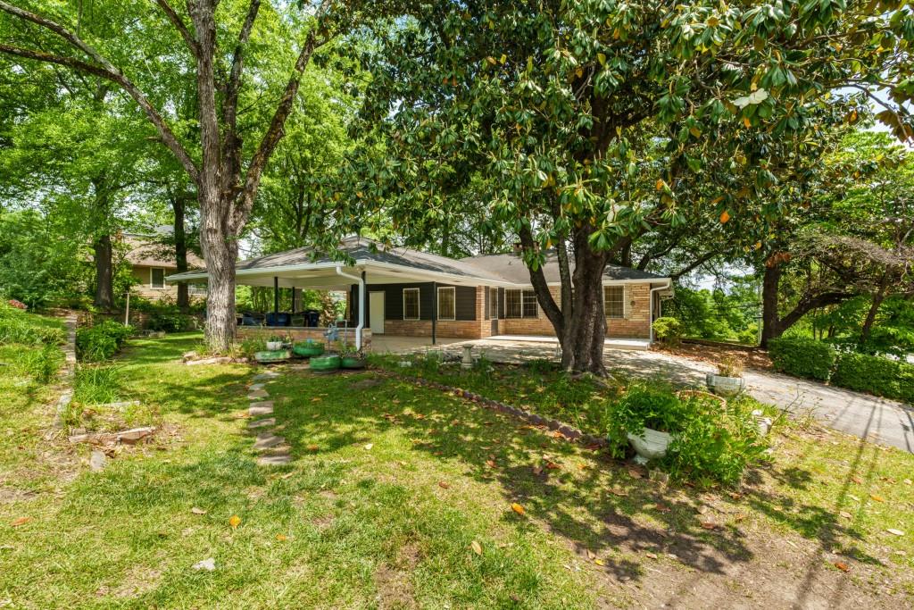 This spacious and newly renovated home at 1930 Hollywood Rd. offers features rarely found in the area. In addition to four bedrooms and two updated bathrooms, the property boasts a two-car carport plus a drive under garage deep enough to accommodate three more vehicles-perfect for a workshop, extra storage, or your favorite hobbies. The house is significantly larger than most in the neighborhood, providing ample living space for families or roommates. Enjoy a generous bonus room just off the carport, ideal for hobbies, laundry, storage room, office, or play area. Entertain with ease in the separate, oversized dining room, perfect for gatherings and special occasions. This move-in ready home combines comfort, versatility, and exceptional space in a prime Atlanta location. Great big living room with a beautiful brick fireplace.