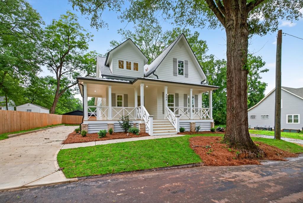 The custom built Murphy plan, modern southern charmer in the heart of downtown Monroe. Welcome to your dream home, a stunning custom-built retreat nestled in the heart of highly sought after Downtown Monroe. Just steps away from charming boutiques, local dining, and year around entertainment, this home offers a lifestyle of walkability, warmth, and true community connection. From the moment you arrive, the wraparound front porch and wide welcoming staircase makes a lasting impression, exuding Southern hosipitality and timeless curb appeal. Inside, a grand two-story foyer sets the tone with soaring ceilings and abundant natural light that flows efforlessley into the open-concept main level. The heart of the home is the expansive designed for both function and style with an oversized island, custom cabinetry, and walk-in pantry plus a butler's pantry for seamless entertaining. The spacious great room invite you to relax with your friends and family by the fireplace with custom trim. Tucked away for privacy from the main living area is the luxurious primary suite features a spa-insprired bathroom with beautiful tilework and large open shower that connects to the primary walk-in closet, this will be a peaceful retreat for an owner. The main level also includes a separate formal dining room, a beautifully appointed powder room, and generous sized laundry room with custom cabinetry and a bonus convenient laundry sink. Step put back to your private covered reach porch, where a cozy brick fireplace creates the perfect setting for evening cocktails or cool fall nights. Whether you're enjoying coffee on the front porch or walking to dinner downtown, this home combines high-end finishes with a welcoming, walkable location in one of Monroe's most beloved areas.