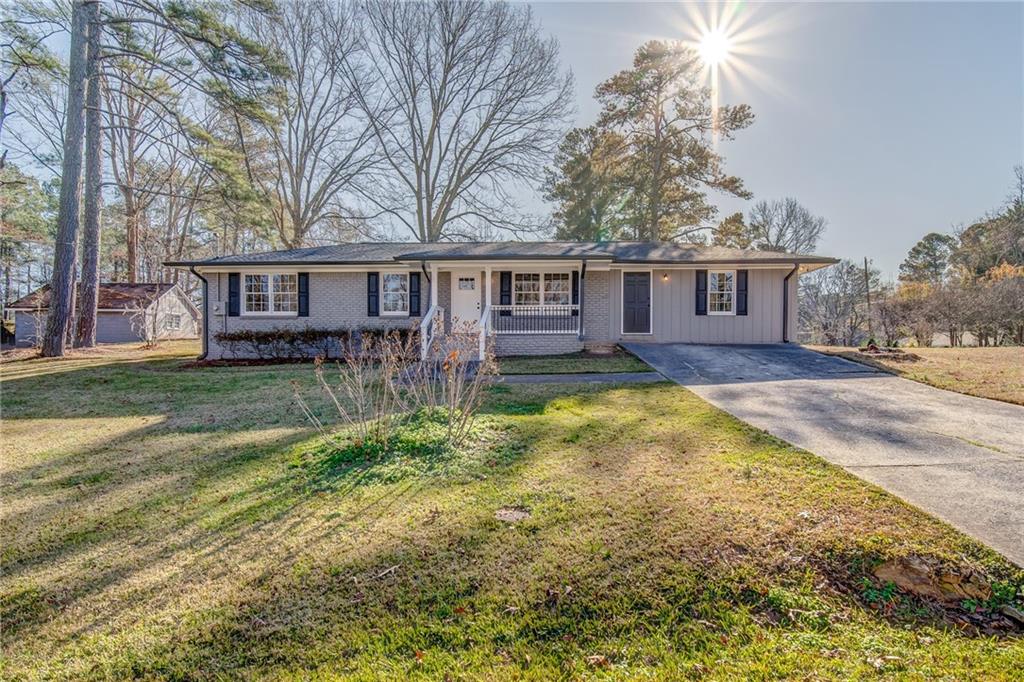 Beautifully renovated single story brick ranch in a quiet, established neighborhood in Austell. Corner lot home on the end of the street minutes away from the Silver Comet Trail, schools and shopping. New roof, gutters, tankless water heater, ss appliances, solid surface counters. Freshly restored hardwood floors, sunroom off of the kitchen, spacious master suite with en-suite bathroom. 3 rooms down the hall share a spacious bath with tub/shower combo. Both baths have new tile floors while sunroom & kitchen have easy care vinyl. Original brick feature walls keep all of the charm. Flat backyard has an outbuilding workshop with power for plenty of storage.