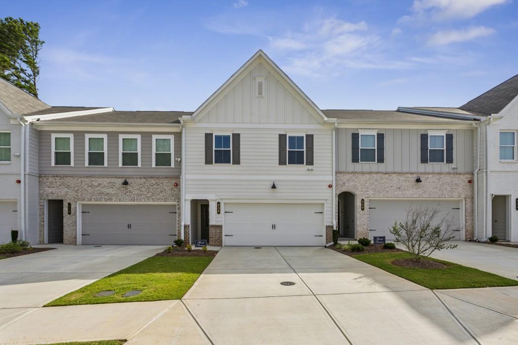 Immaculate 2023-Built Townhome in the Sought-After Gates at Hamilton Grove! Step inside and be instantly wowed by the abundance of Natural Light, Open Floor Plan, Tall Ceilings, and elegant Crown Molding. Designed with comfort and style in mind, this home showcases durable Luxury Vinyl Plank Flooring throughout both levels and energy-efficient Double Pane Windows for year-round savings utilities are exceptionally low! The Gourmet Chef's Kitchen is the heart of the home, boasting Quartz Countertops, Stainless Steel Appliances, White Cabinets, a classic Herringbone Subway Tile Backsplash, a Walk-In Pantry, Large Center Island, and stylish Glass Pendant Lighting. With a seamless view into the Fireside Living Room, entertaining is effortless. A spacious Dining Area flows perfectly to the Private Back Patio, offering the ideal setup for indoor-outdoor living. A Convenient Half Bath completes the Main Level. Upstairs, the Loft Area provides a versatile flex space perfect for a Home Office, Study Nook, or Playroom. The Massive Owner's Suite easily accommodates a king bed and Sitting Area, complemented by a Spa-Like En Suite with a Double Vanity, Glass & Tile Shower, and an Oversized Walk-In Closet. Two Additional Spacious bedrooms share a beautifully appointed Full Bath, offering flexible space for guests, a home gym, or additional work-from-home needs. A full-size laundry room completes the upper level. Enjoy the convenience of a Two-Car Garage and the peace of mind of upcoming privacy fencing to soon be installed. Community amenities include a Swimming Pool, Playground, Fire Pit, and expansive Green Spaces. Located just minutes from Whole Foods, Kennesaw State University, Kennesaw Marketplace, Town Center Mall, Marietta Square, Kennesaw Mountain Park, and Kennestone Hospital, this home offers unbeatable access to shopping, dining, outdoor recreation, and major highways (I-75, I-575, US 41). Kennesaw Mountain is less than 2 miles away perfect for hiking, picnics, or even horseback riding! Don't miss your chance to own this turnkey gem in one of Marietta's most vibrant and convenient communities this one truly has it all!