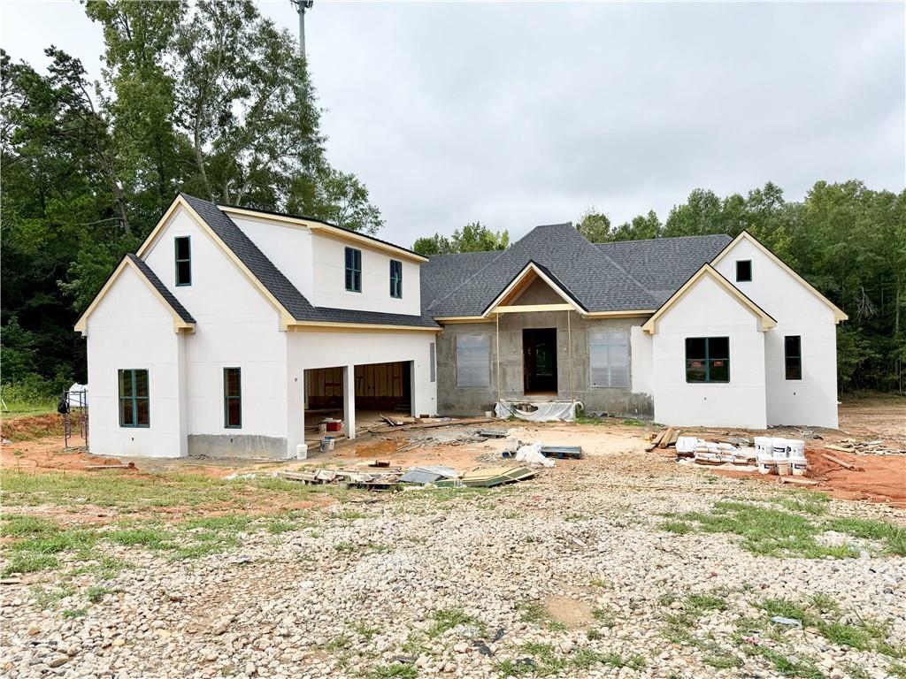 Welcome to your dream home! This exquisite new construction open-ranch design features a main-level owner's suite and offers the perfect blend of luxury, elegance, and modern living. As you enter, you'll be welcomed by sophisticated private study and a bright and airy dining room. The open floor plan effortlessly flows through the family room, gourmet kitchen, breakfast room and outdoor living area creating an ideal layout for entertaining and family gatherings. The chef's kitchen is a true paradise, equipped with premium stainless steel appliances, stunning quartz countertops, and a spacious center island with seating. The large scullery and pantry provides additional workspace and storage with a second stove, cooktop and sink. The master suite is a peaceful retreat, featuring a generously sized bedroom with tray ceilings, a large walk-in closet, and a spa-like en-suite bathroom. Unwind in the luxurious bath, complete with a double vanity, a freestanding soaking tub, and a walk-in shower. The laundry room, mud room and a half bath are conveniently located on the same wing. The main level also includes three additional bedrooms each with a large walk-in closet and a private bathroom. Upstairs, a spacious bonus/media room provides extra flexibility. The full, unfinished terrace level offers unlimited potential for future customization. Step outside to your private backyard oasis, perfect for relaxation or entertaining. The expansive screened porch, covered deck and outdoor kitchen is ready to become your outdoor sanctuary. Plenty of space for a pool, garden or outdoor entertaining. Located in a sought after area, this home offers easy access to golf courses, shopping centers, dining, parks and healthcare. No HOA and situated on 1+ acre.