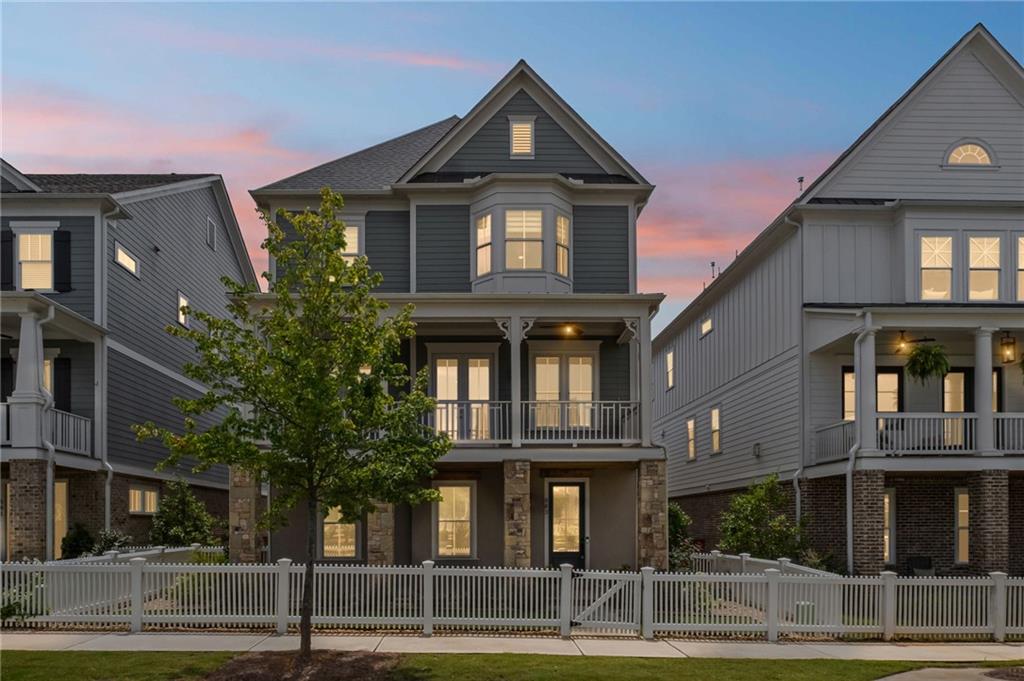 Experience Elevated Living at South on Main – Downtown Woodstock’s Most Coveted Luxury Community. Welcome to your dream home in the heart of vibrant Downtown Woodstock! Nestled in the premier South on Main neighborhood, this impeccably designed, nearly new 3-story masterpiece is just steps from top-tier restaurants, boutique shopping, and year-round events. Built only 2 years ago and packed with luxury upgrades, this home seamlessly combines modern sophistication with timeless elegance. Boasting 4 spacious bedrooms, 4.5 designer baths, and your very own private elevator, this residence is built for effortless entertaining and everyday ease. The main level offers a fluid open-concept layout adorned with rich hardwoods, custom molding, and designer finishes throughout. Enjoy a dedicated home office, a refined formal dining room, and a warm, inviting family room with a fireplace featuring a custom mantel and bespoke trim work. The chef’s kitchen is a true showpiece, equipped with Silestone Cosentino quartz countertops, a high-end Thermador range, custom vent hood, waterfall-edge island, quartz backsplash, a stainless apron-front sink, built-in microwave, and soft-close cabinetry—a dream for culinary enthusiasts.
Upstairs, retreat to your luxurious primary suite featuring a spa-like ensuite with soaking tub, quartz counters, oversized walk-in shower, and designer tile selections. The terrace level includes a generously sized flex room with a full bath—ideal for guests, a gym, or a private workspace. Step outside and enjoy two fabulous outdoor spaces: a covered front porch with Trex decking overlooking community gardens and firepits, and a freshly stained wraparound back deck perfect for evening gatherings under the stars. Additional features include: Custom blinds and roller shades, Designer lighting throughout, 3-car garage with professional epoxy floors, Whole-house water filtration system and Professionally landscaped grounds.
South on Main offers unmatched community amenities: a resort-style pool, clubhouse, fitness center, two dog parks, an amphitheater, and a full calendar of concerts, festivals, and neighborhood events. Direct access to the Noonday Trail adds even more to love.
Skip the wait and expense of new construction—this turnkey, gently lived-in home is move-in ready and brimming with upgrades you won’t find elsewhere.
Schedule your private tour today and experience the best of Downtown Woodstock living!