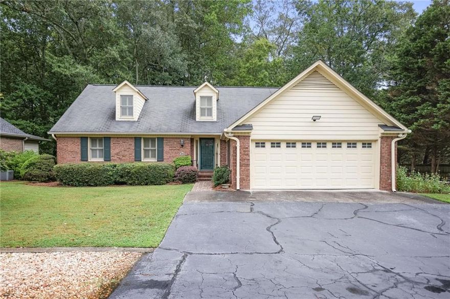 Rare Opportunity – One of Only Two Detached Homes in Sought-After Marietta Ranch Townhome Community,  Enjoy the best of both worlds with this unique, detached home located in a small, centrally located ranch-style community in Marietta City. Offering the perfect blend of privacy and low-maintenance living, this home is ideal for those seeking comfort, convenience, and accessibility.  Inside, you'll find two spacious bedrooms on the main floor, wide hallways for easy navigation, and a bright, open-concept layout. The kitchen and dining area features granite countertops, stainless steel KitchenAid appliances. The great room boasts cathedral ceilings and flows seamlessly into a cozy, wood-paneled sunroom that opens to a large, private deck—perfect for morning coffee or evening relaxation. Upstairs offers two additional bedrooms, a full bath, a versatile living space, and generous storage throughout. Outside, enjoy tranquil, low-maintenance landscaping, with a natural buffer of mature trees and a peaceful stream creating a private, serene backdrop. Additional highlights include a well-maintained interior and exterior, a 2-car garage, and a location that puts you close to everything Marietta has to offer.