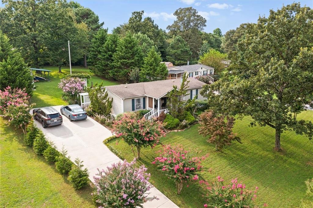 Beautifully maintained and truly one of the most well-cared-for properties you'll find! Custom finishes include a real wood-burning chimney, crown molding, custom-framed windows and window stools, and premium wooden blinds. Kitchen features a porcelain backsplash from a $500k home, all-new stainless steel appliances, and luxury LTV floors, with engineered hardwood in living areas and ceramic tile in baths. Outside offers a new covered porch, cozy front porch with fan, two arbors, custom driveway gate, and extravagant landscaping with like-new concrete driveway. A 16x14 workshop/storage building provides power, fans, workbench, and security camera. This home is move-in ready and already feels perfectly like home!